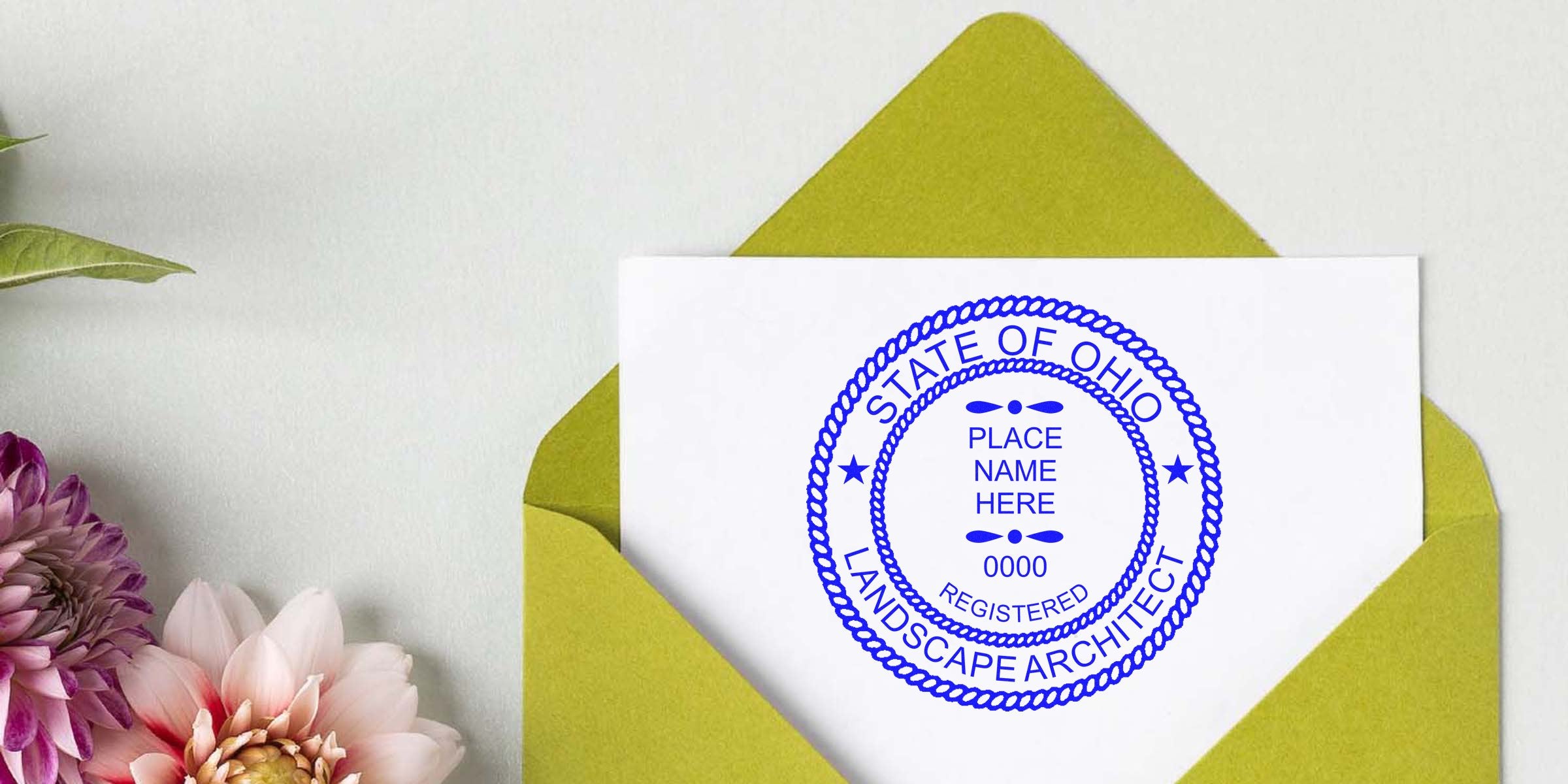 Ohio landscape architect seal on white card inside green envelope, with nearby flowers, displaying seal specifications.