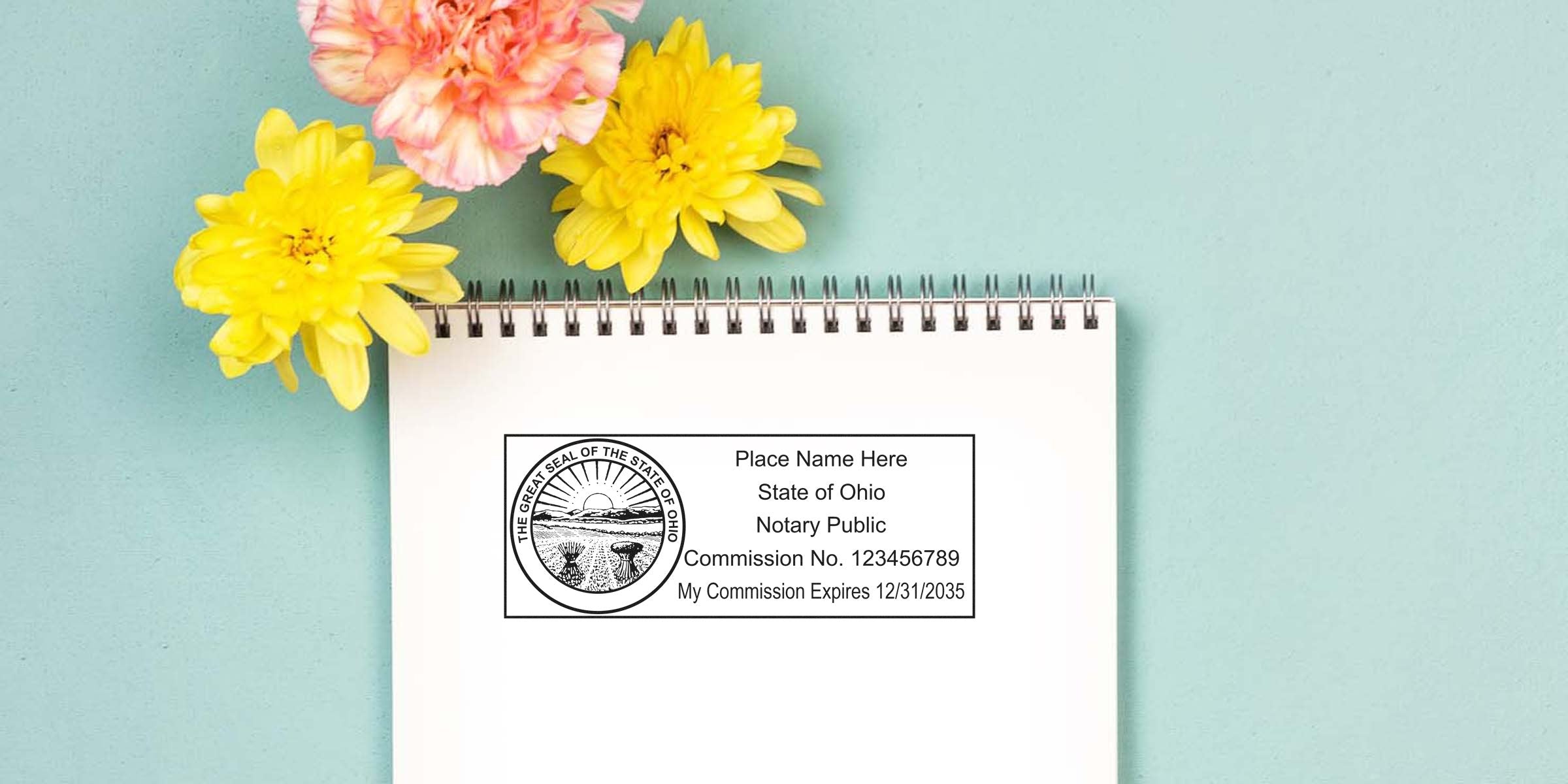 Ohio notary public stamp with commission number and expiration date on a floral notebook, alongside essential Ohio notary supplies and tools.
