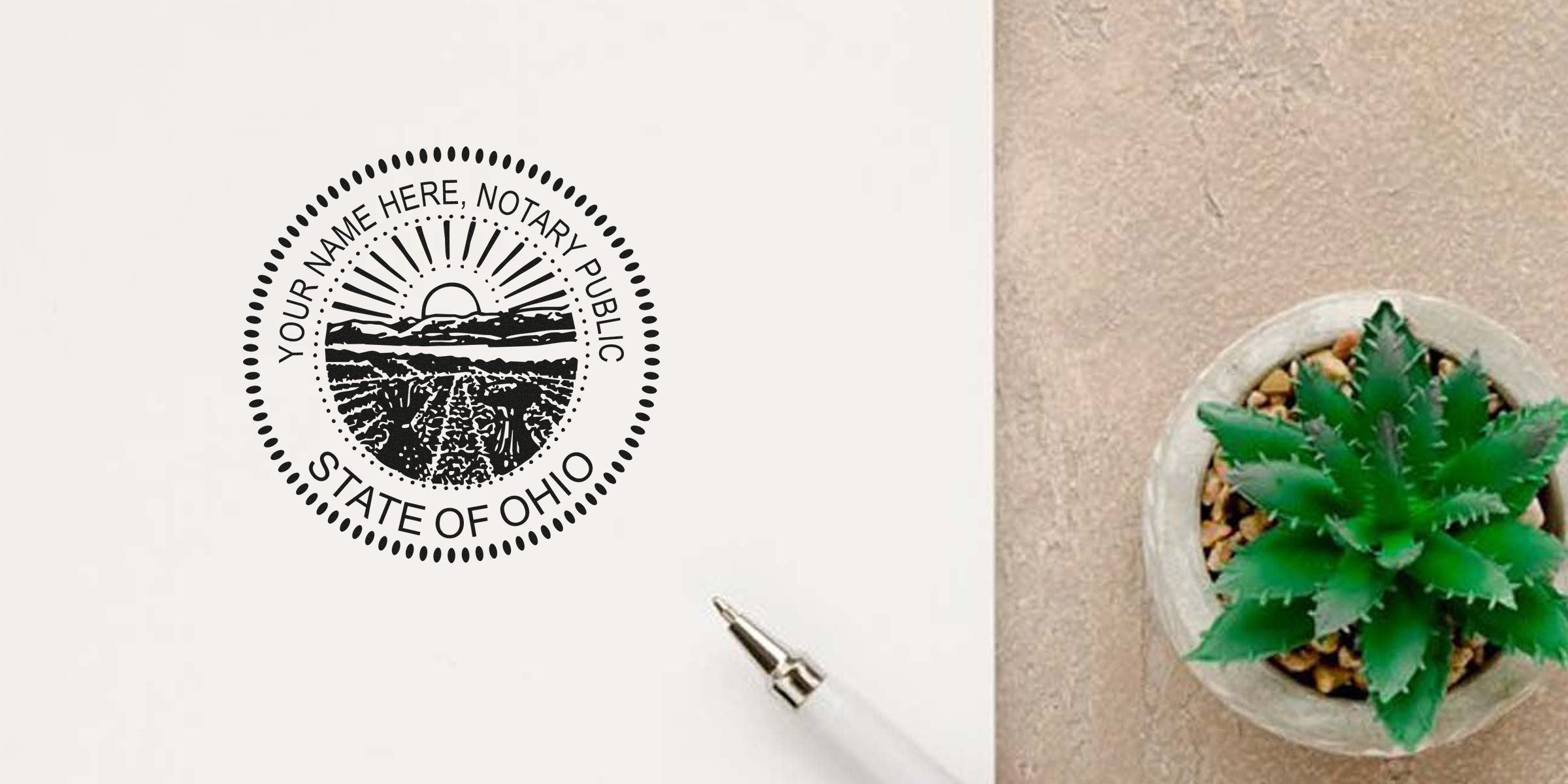 Ohio notary seal stamp with pen and green succulent on beige surface, showing how to obtain an Ohio notary seal.