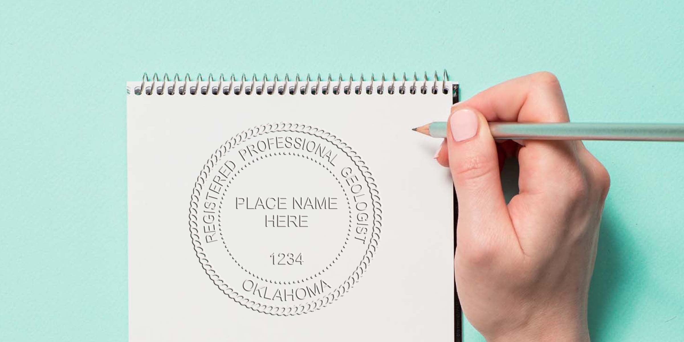 Hand drawing Oklahoma Geologist Seal, a registered professional geologist stamp, on notebook with pencil against blue background, emphasizing the seal's importance.