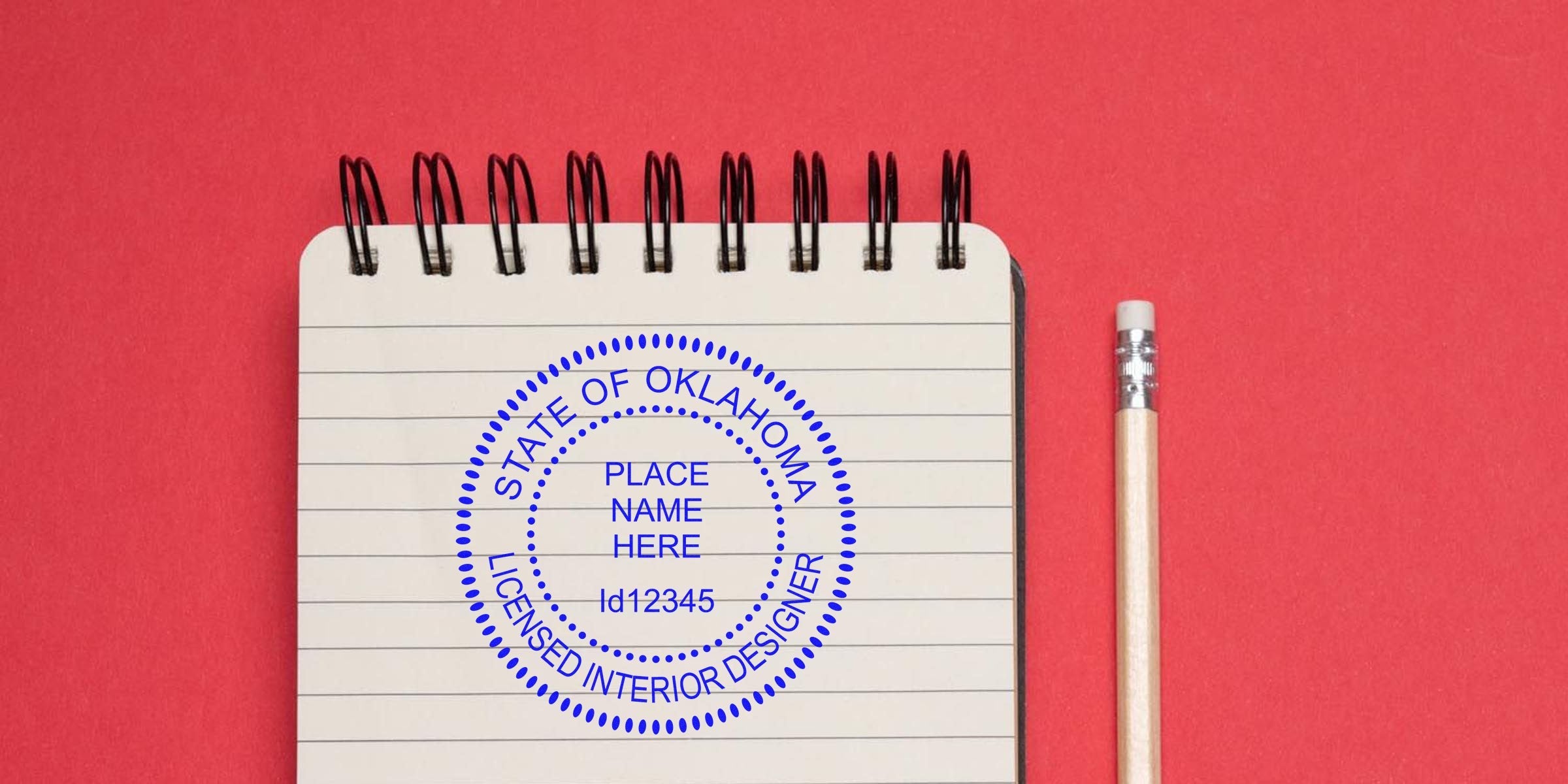 Oklahoma interior design license stamp on notebook with pencil, set against a red background, showcasing stamp design tips.