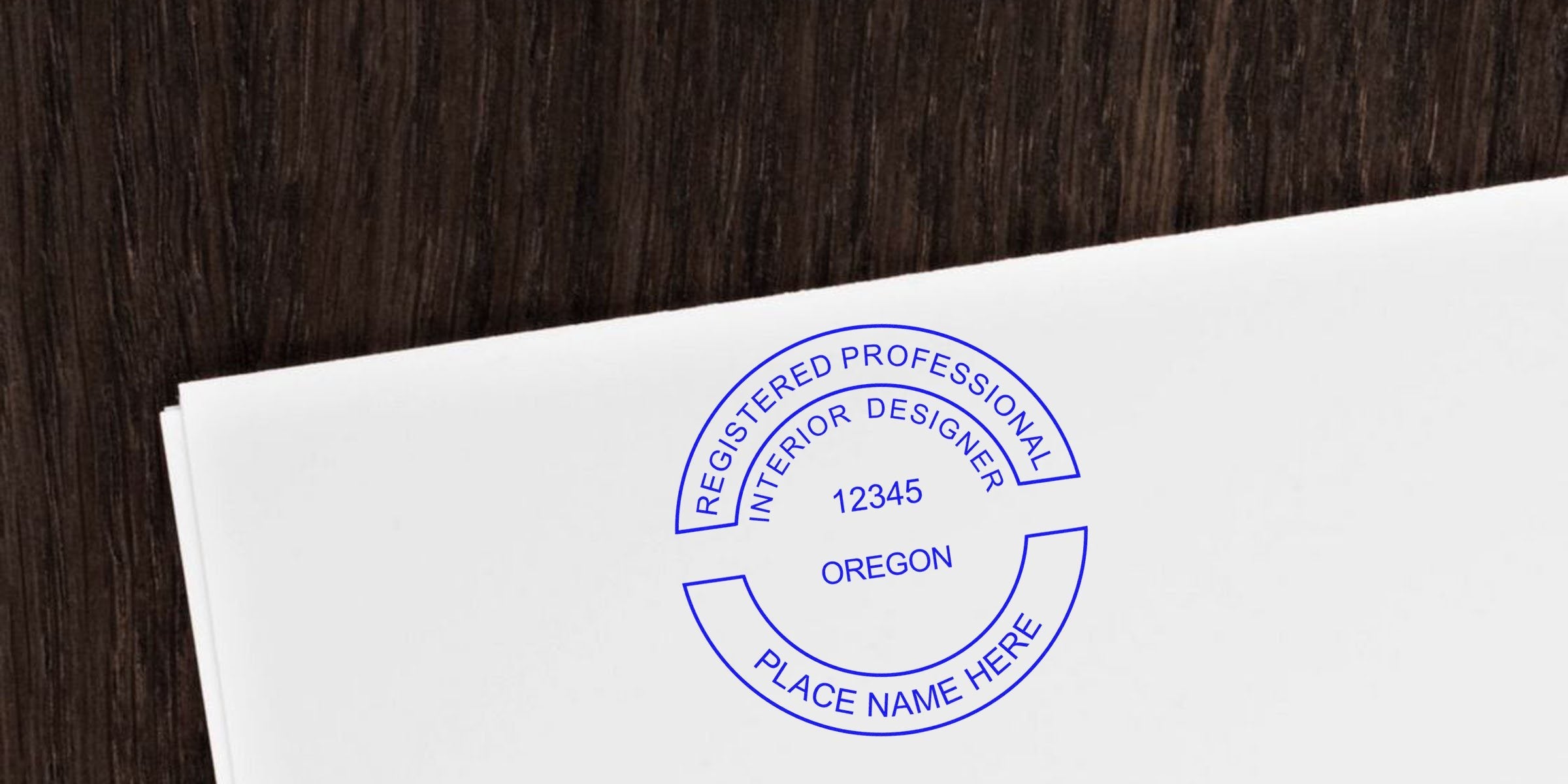 Oregon interior designer renewal stamp on white paper with registered professional interior designer seal, custom name, number, highlighting common stamp errors.