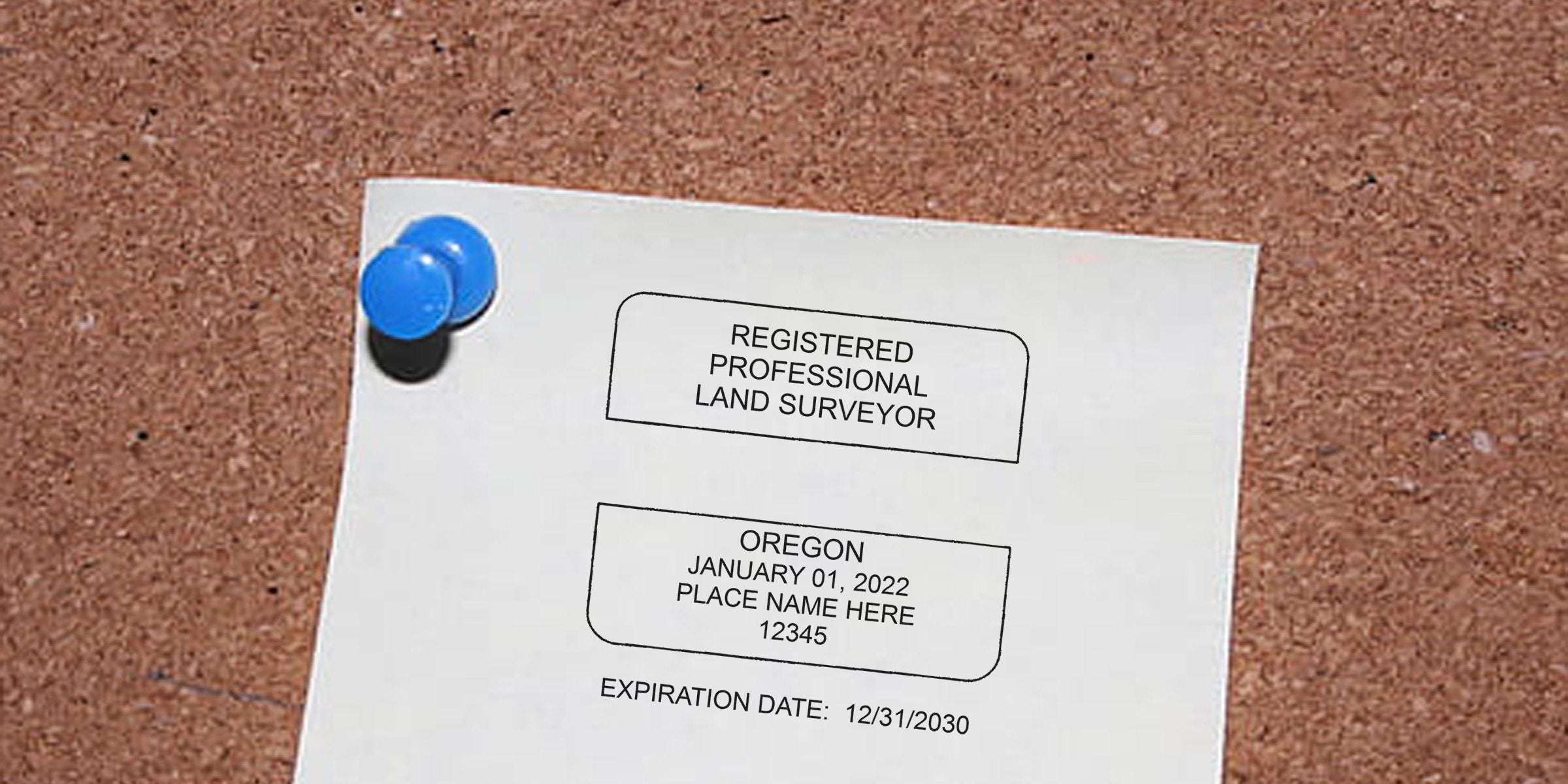 Registered professional land surveyor license pinned on corkboard, showing Oregon seal, official credentials, seal details, and expiration date.