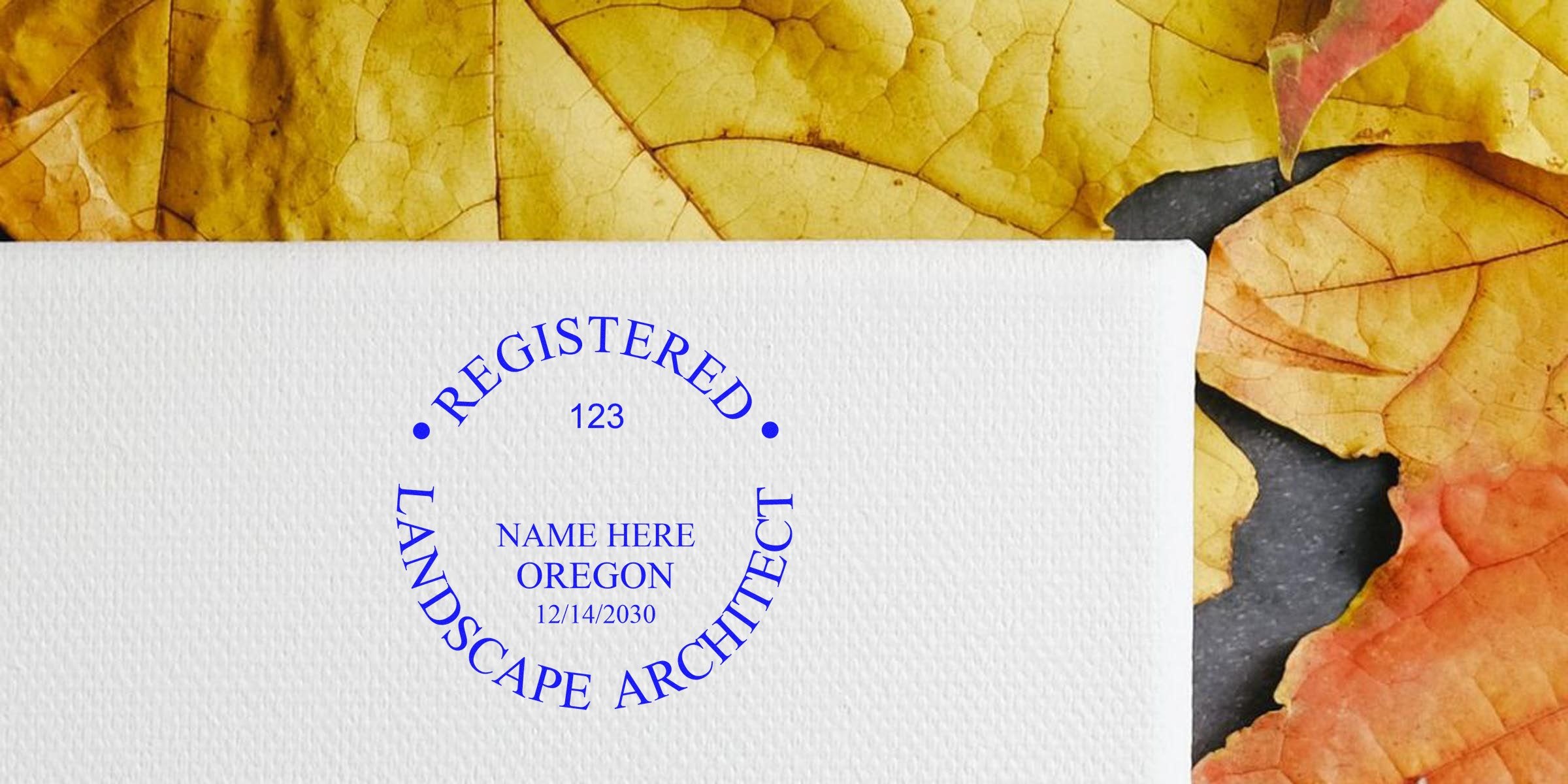 Oregon landscape architect stamp on textured paper with autumn leaves, emphasizing the stamp verification process.