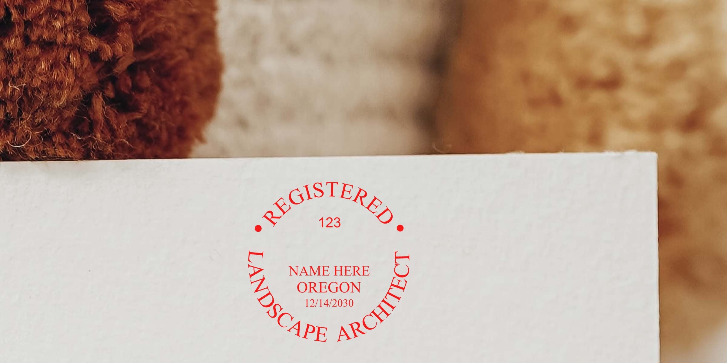 Oregon landscape architect stamp on paper with registered professional certification seal, linked to the landscape architect application process.