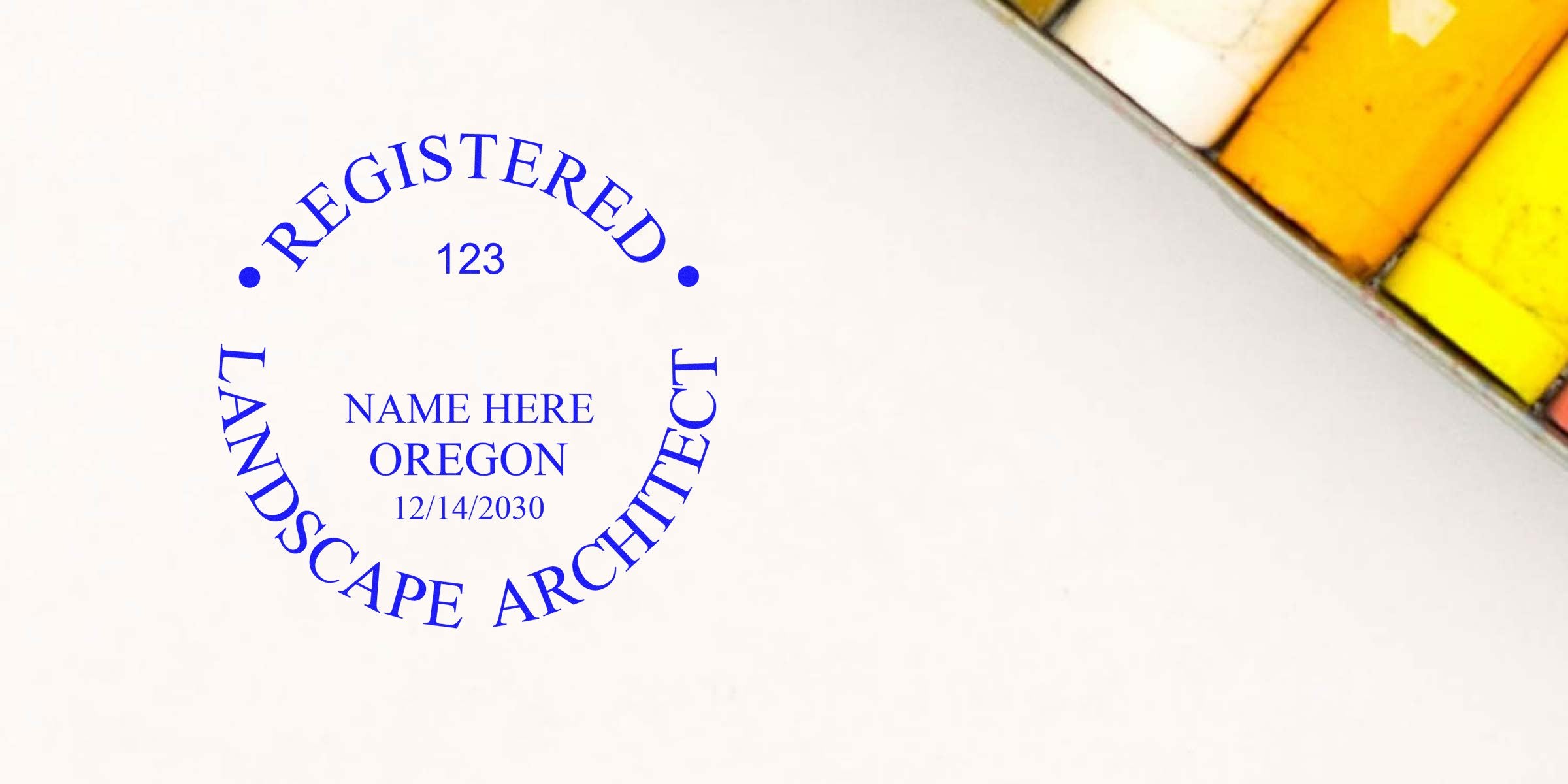 Oregon landscape architect stamp on white paper with pastel chalks, symbolizing stamp and license renewal for Oregon landscape architects.