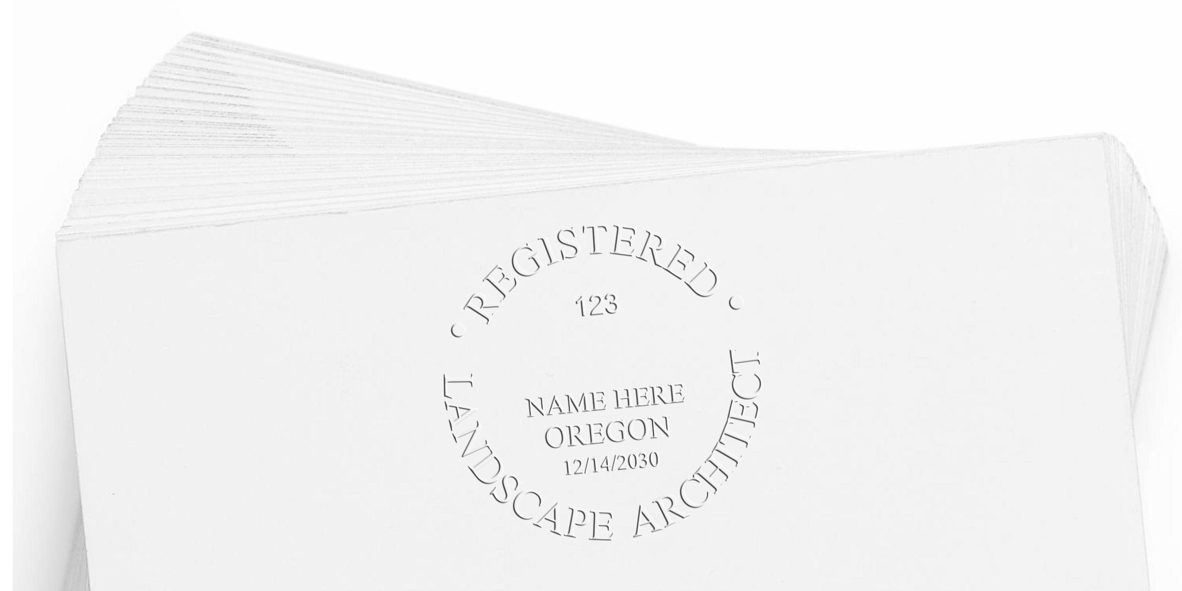 Stack of white embossed business cards for an Oregon-registered landscape architect, showing custom name, registration date, and Landscape Architect Stamp per Oregon guidelines.