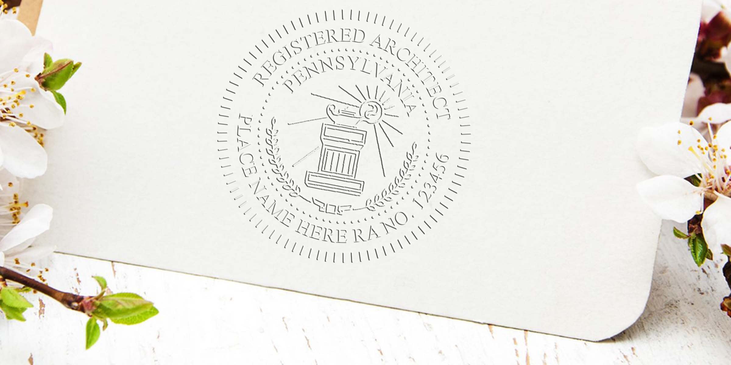 Embossed Pennsylvania architecture stamp on white paper with floral design, custom architect seal meeting Pennsylvania architectural stamp regulations.