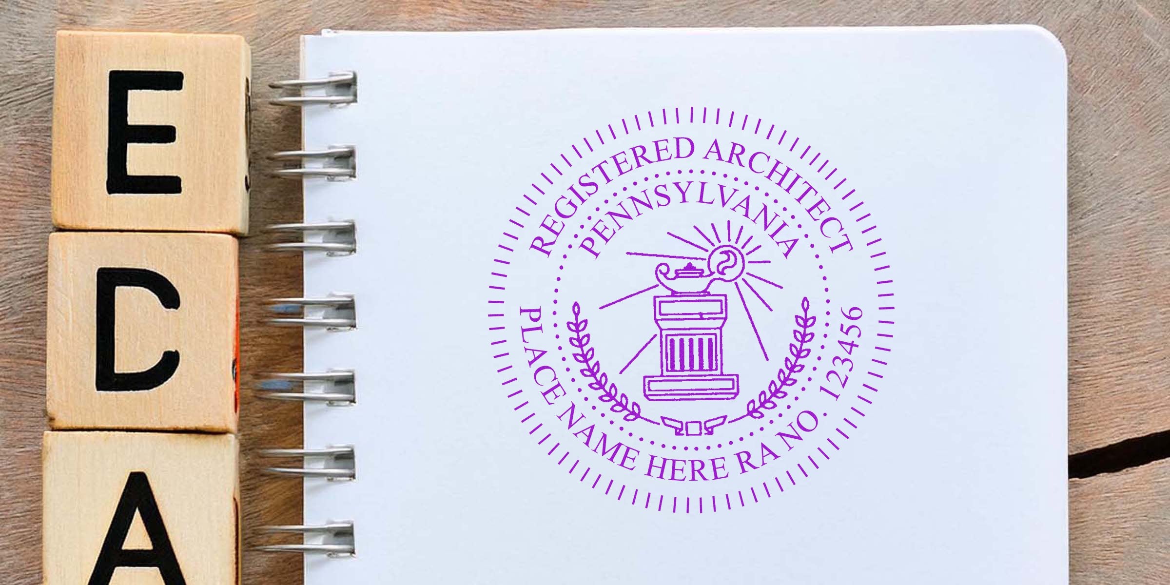 Registered architect seal on notebook with wooden blocks spelling ECA, showing Pennsylvania architect stamp size and seal requirements for professional certification.