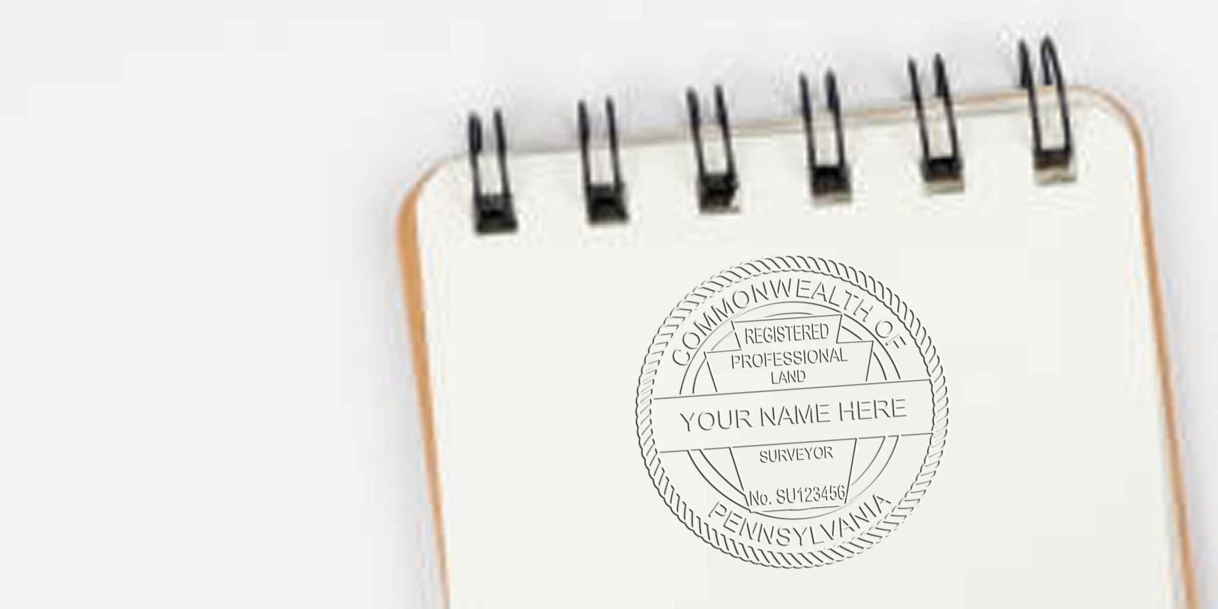 Custom professional land surveyor seal stamp on spiral notebook, compliant with Pennsylvania land surveyor stamp laws and PA requirements.