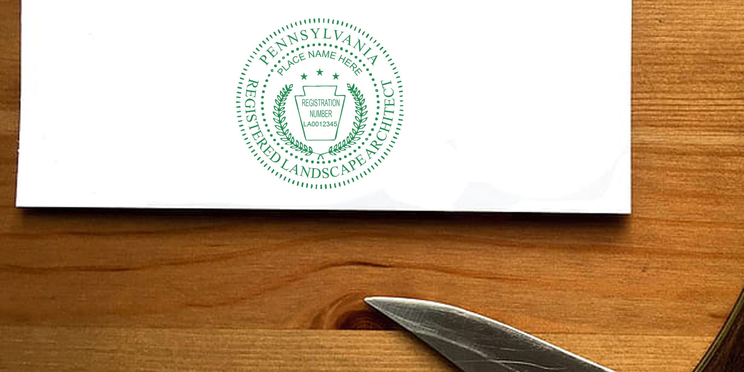Official Pennsylvania landscape architect seal on white paper with wooden desk background, displaying PA landscape architect seal samples meeting all official requirements.