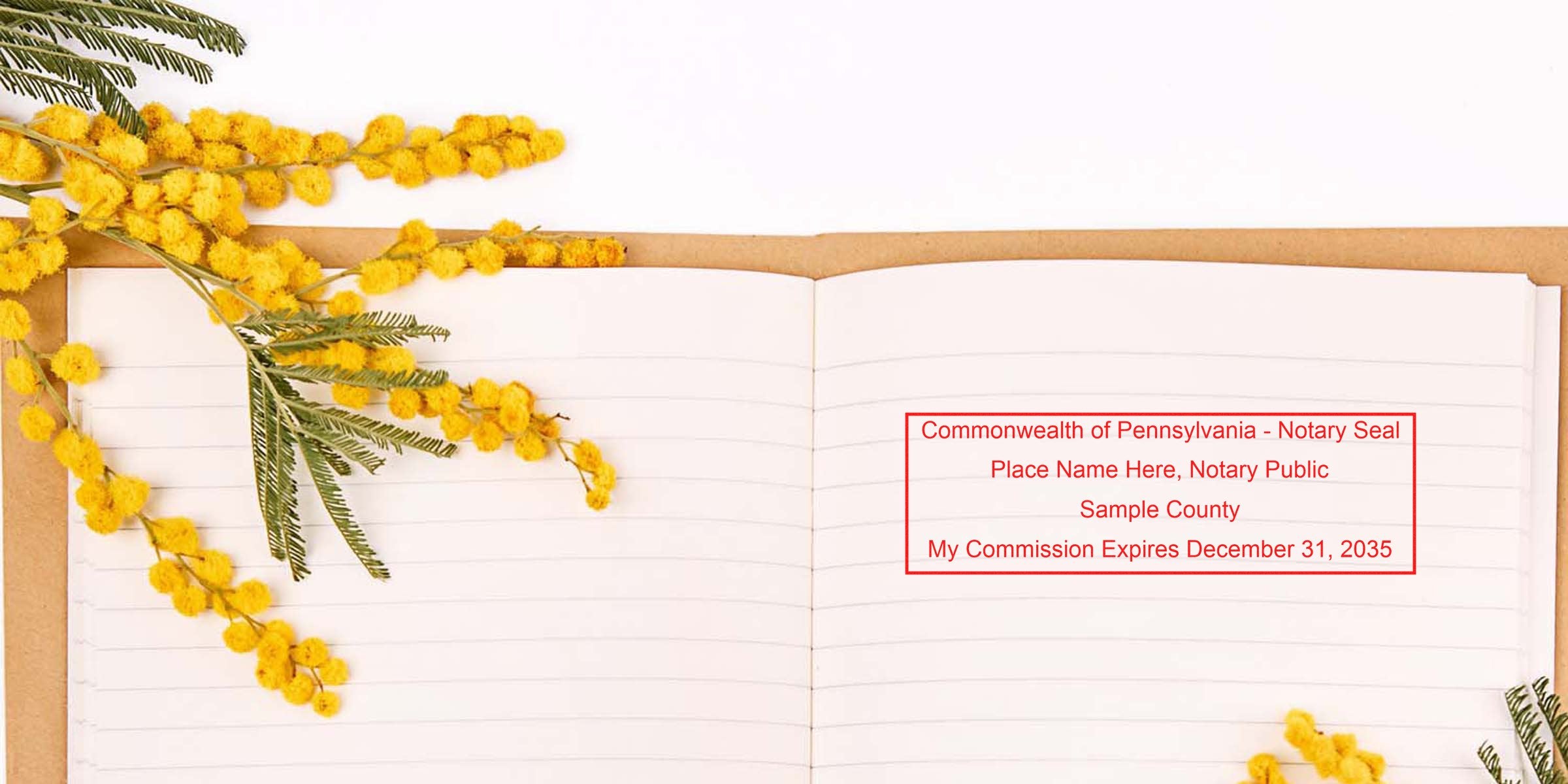 Open notebook with yellow mimosa flowers and Pennsylvania state seal stamp on lined pages.