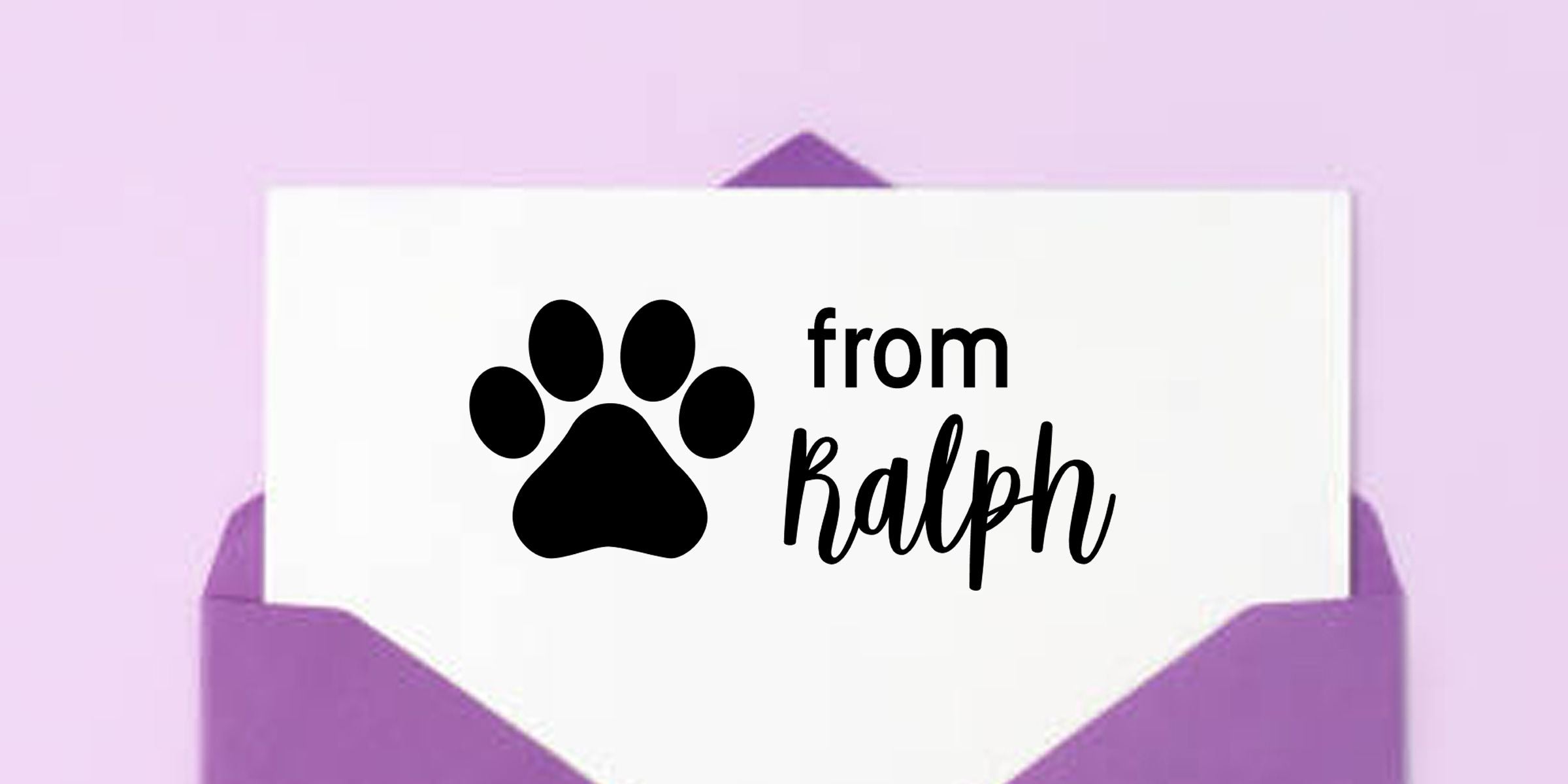 White greeting card in a purple envelope featuring a black paw print and the text “from Ralph” on a lavender background.