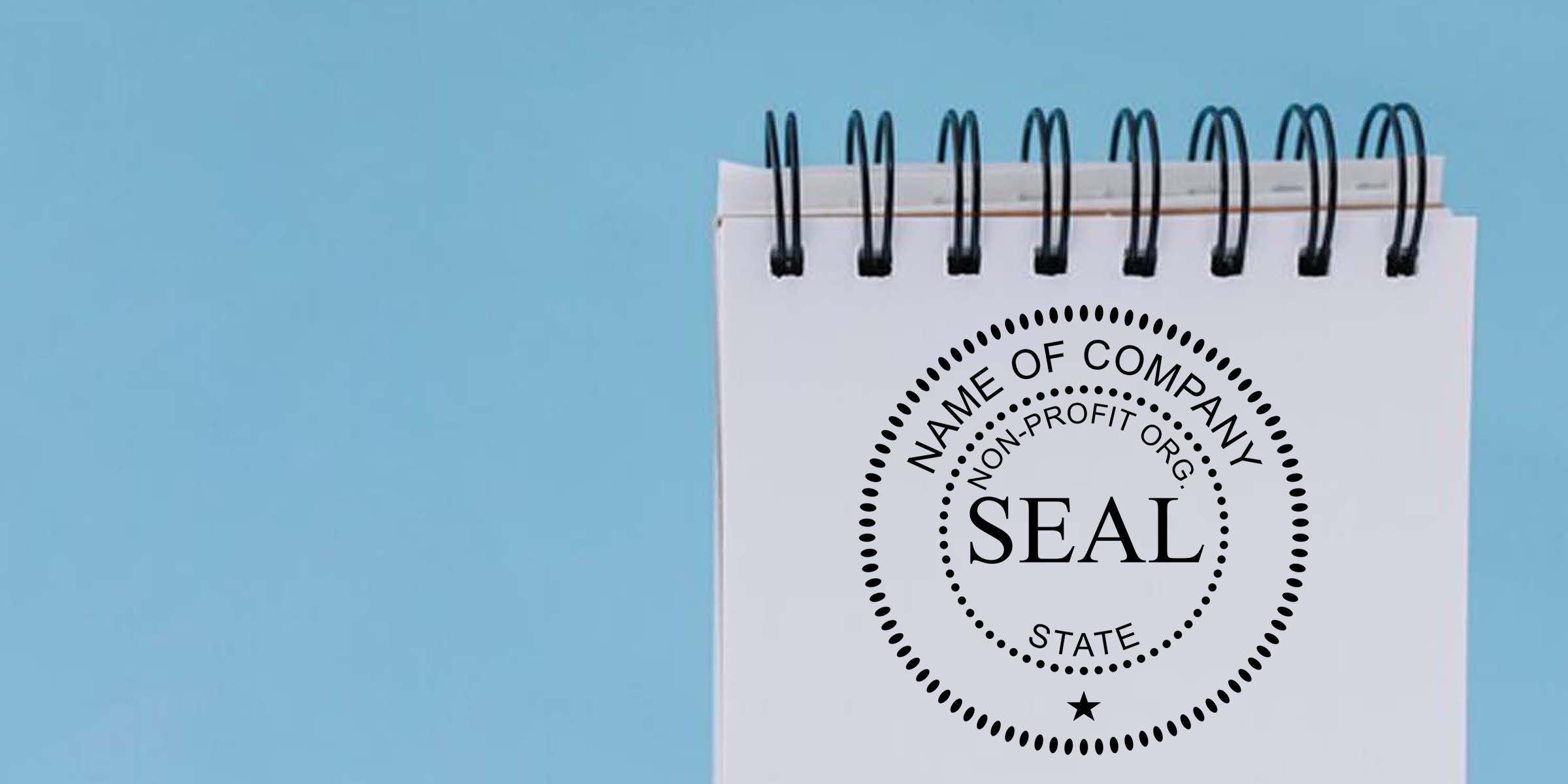 Spiral notebook with nonprofit organization seal logo on a light blue background