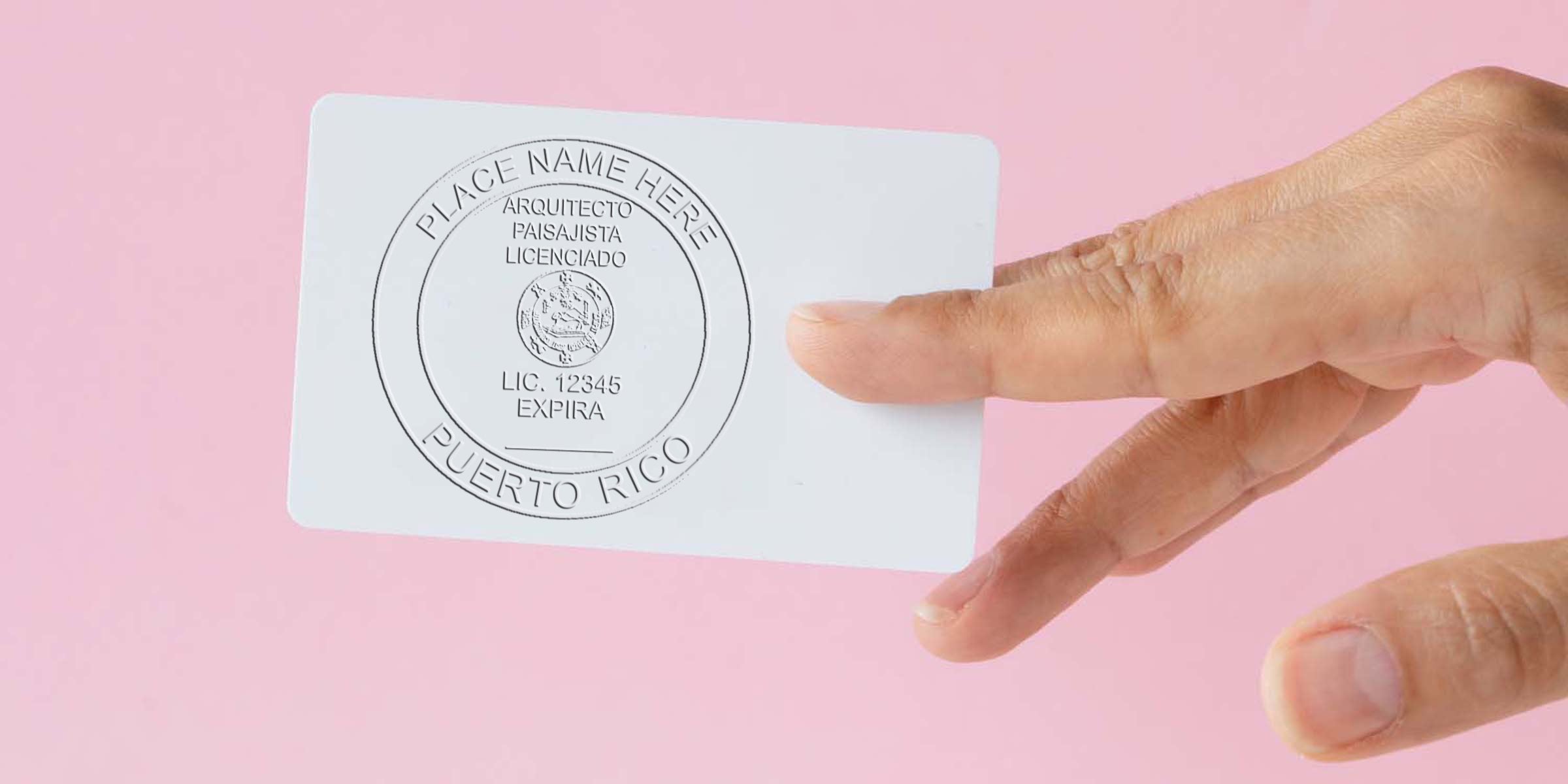 Hand holding a Puerto Rico licensed architect and landscape architect card with the Puerto Rico landscape architect seal, next to a landscape architect embosser on a pink background.