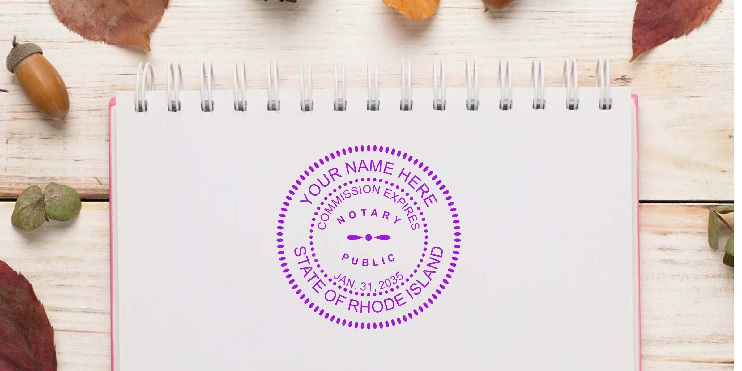 Rhode Island notary public stamp with commission expiry on notebook, surrounded by autumn leaves and acorns, showcasing items from Rhode Island Notary Starter Kit and Notary Kit Rhode Island.
