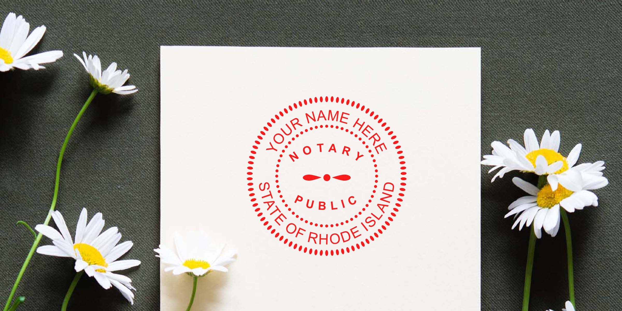 Rhode Island notary stamp on white paper, surrounded by daisies on dark fabric—ideal for anyone seeking to buy a Rhode Island notary stamp.