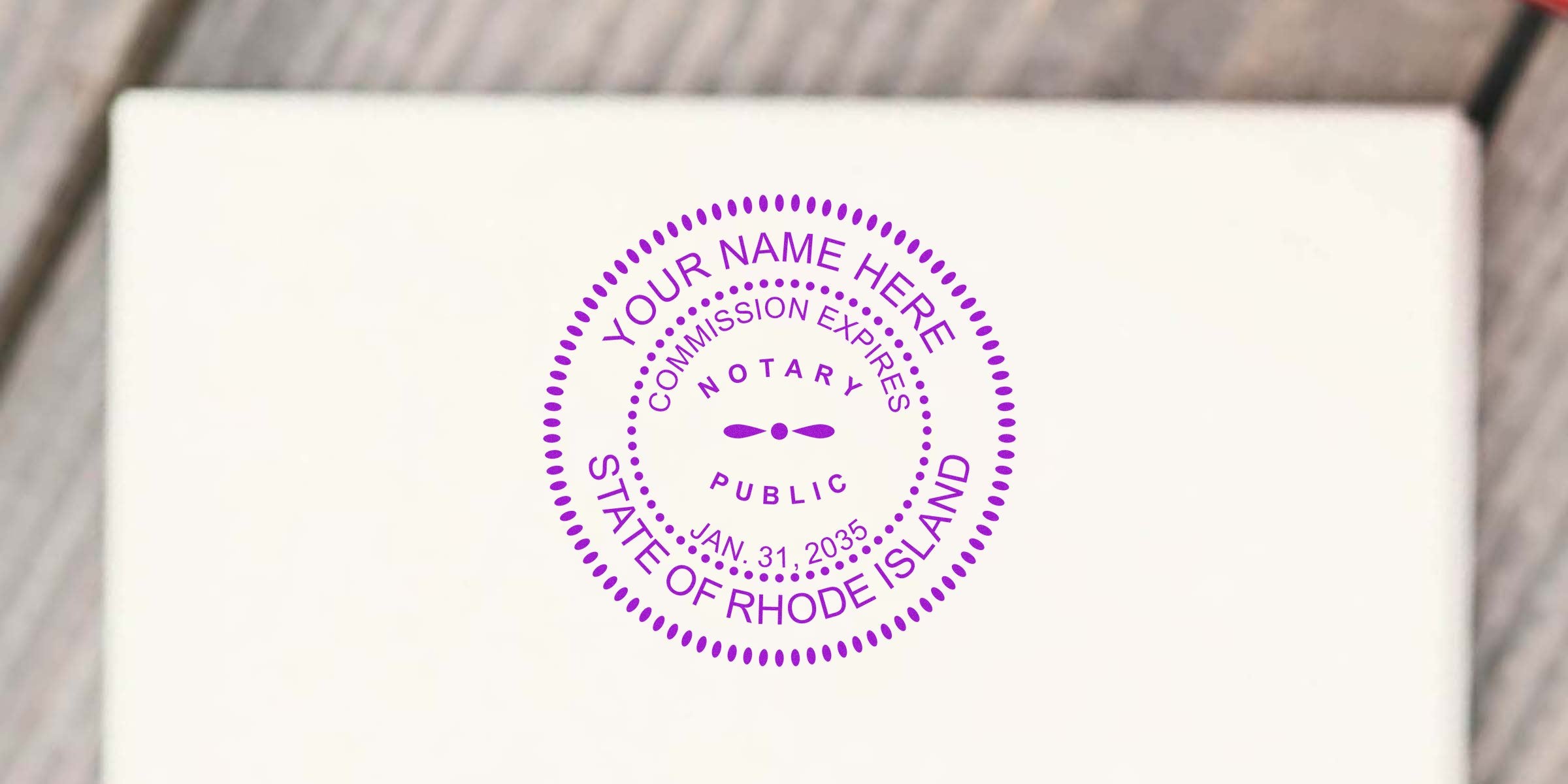 Rhode Island notary public stamp on white paper with commission expiration date, demonstrating how to become a notary in RI.