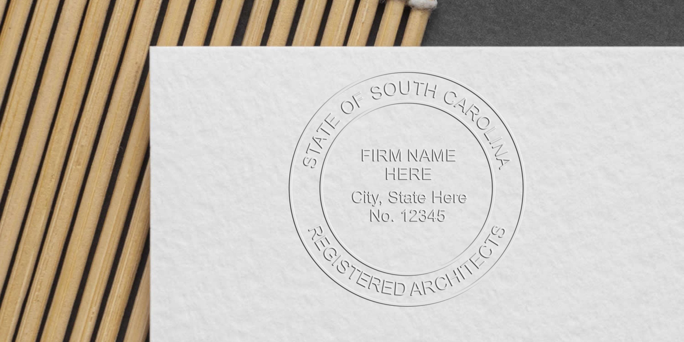 South Carolina architect seal embossed on white paper, showing the registered architects firm seal; refer to the architect seal embosser guide for details.
