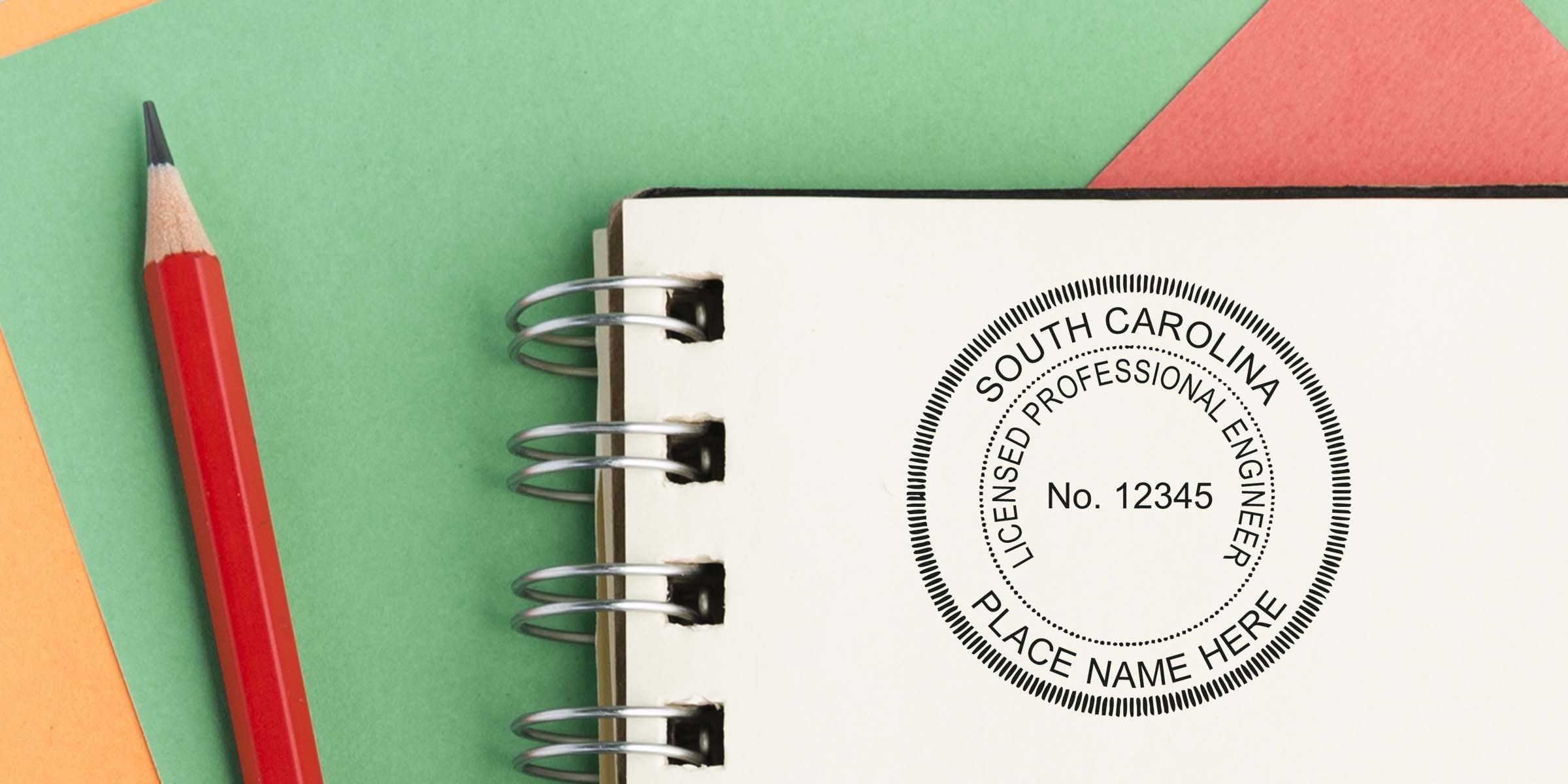 South Carolina engineer seal embossed on a notebook with a red pencil on a colorful background, showcasing a professional embosser.