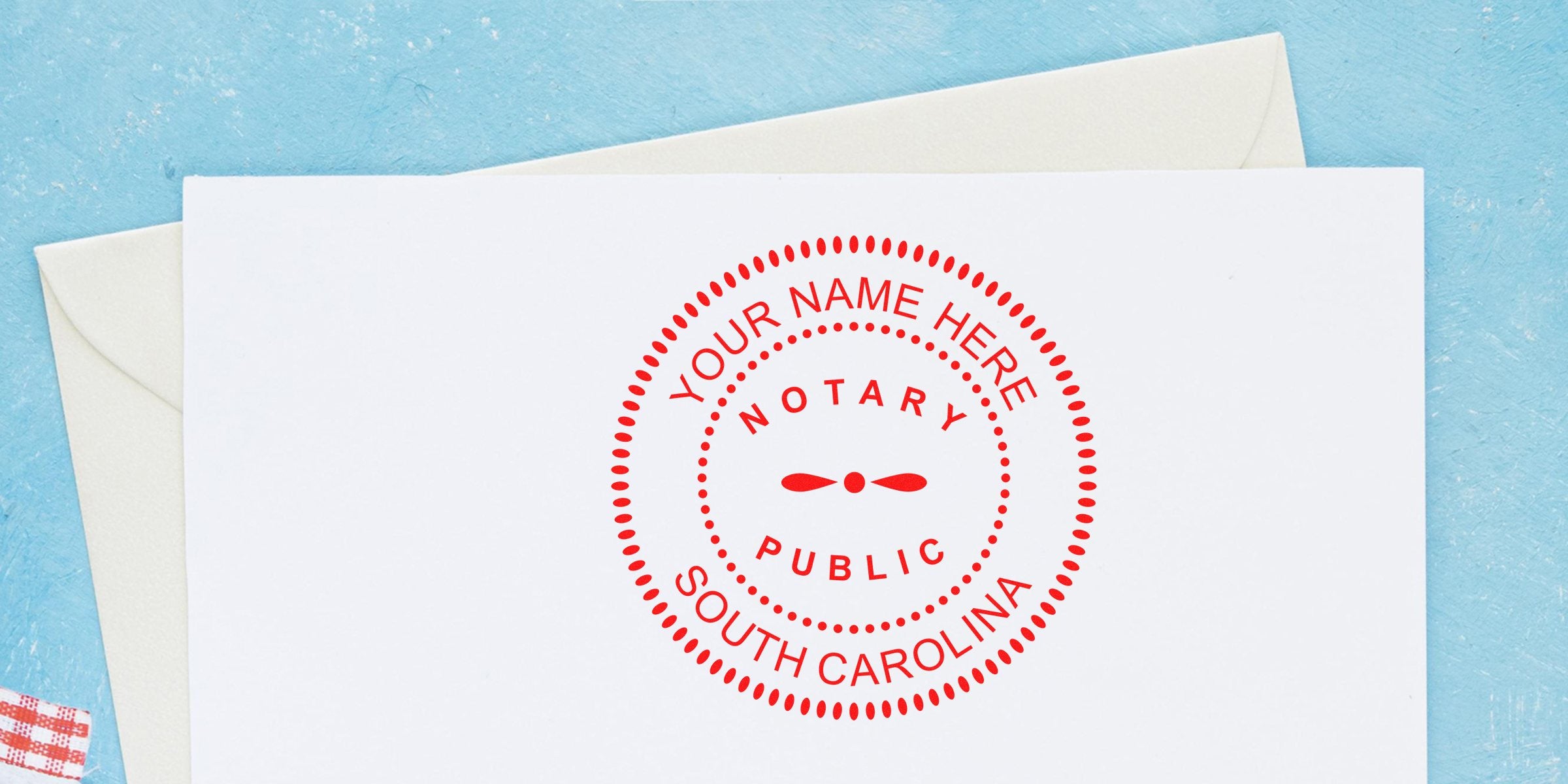 South Carolina notary stamp on white paper with envelope, displaying custom stamp designs on a blue background.