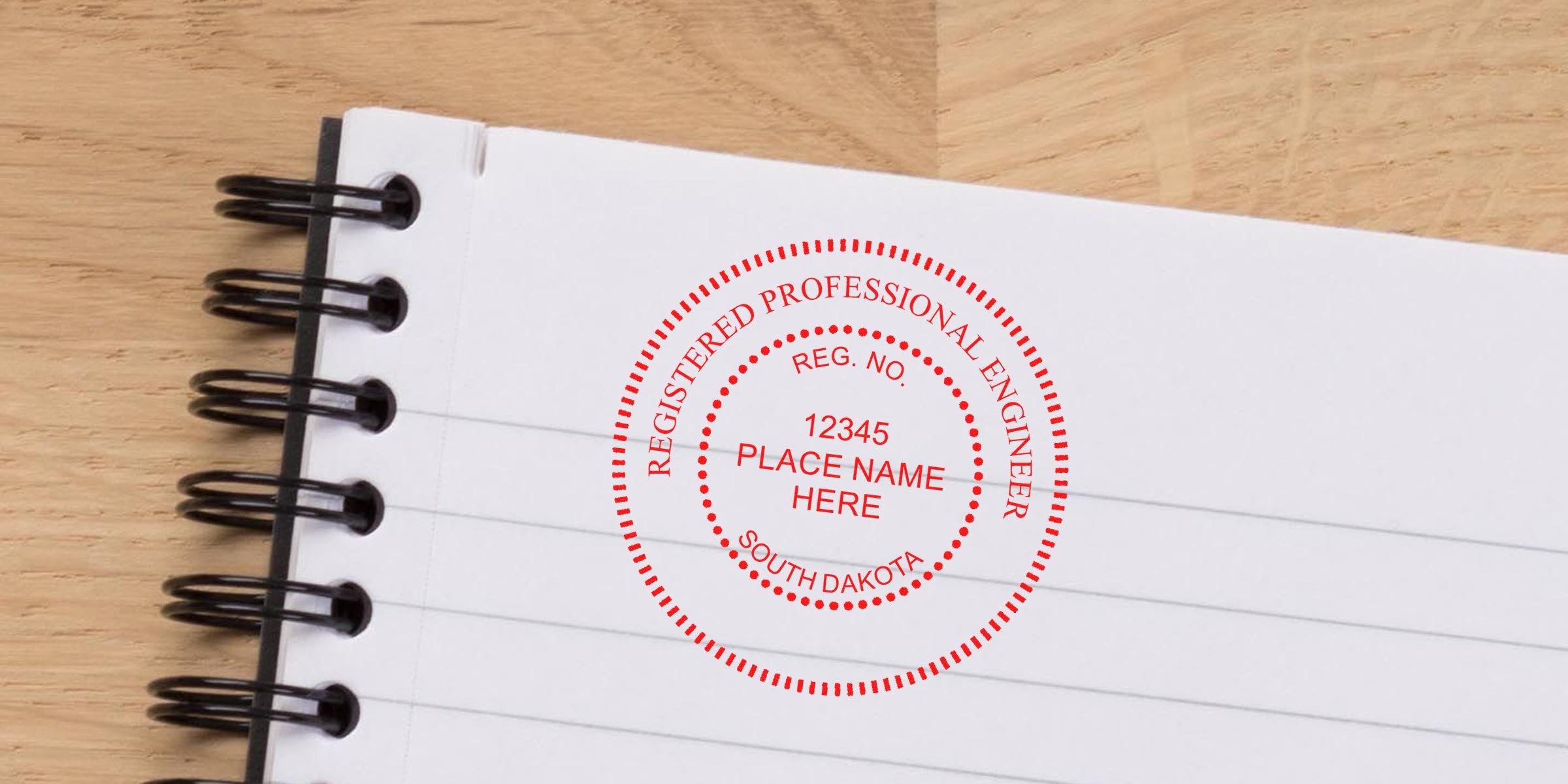 Professional engineer stamp on notebook paper displaying South Dakota engineering seal and stamp requirements.