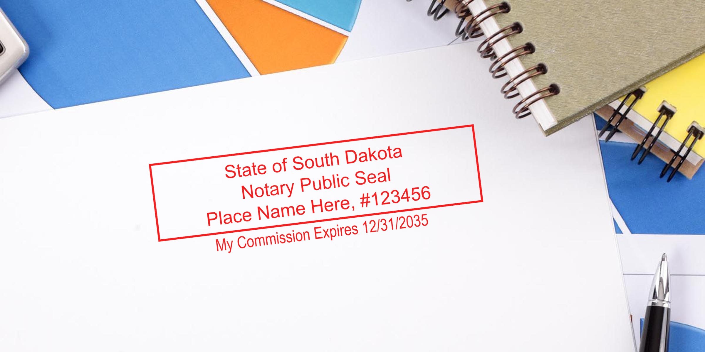 Notary Stamp South Dakota on white paper with office supplies, highlighting tips for buying a notary stamp.