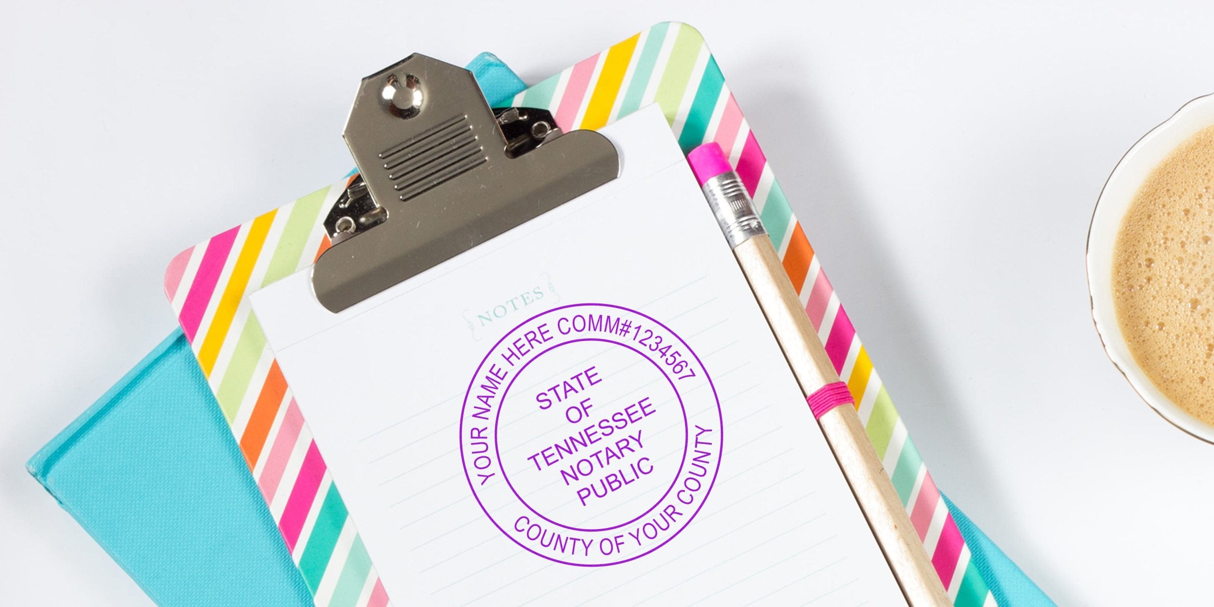 Tennessee notary stamp on clipboard with colorful striped border, pencil, and coffee cup, showcasing an affordable notary seal.