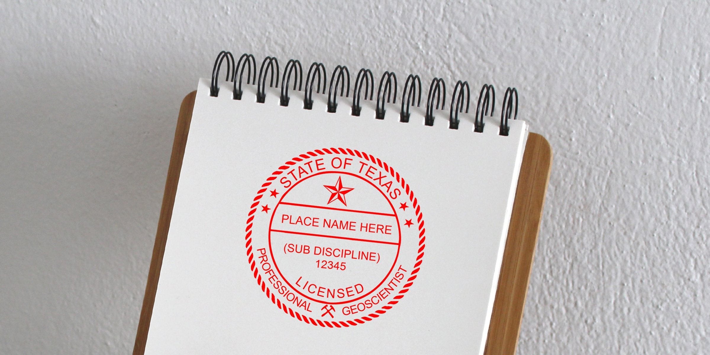 Texas geologist license stamp on spiral notebook showing professional certification requirements.