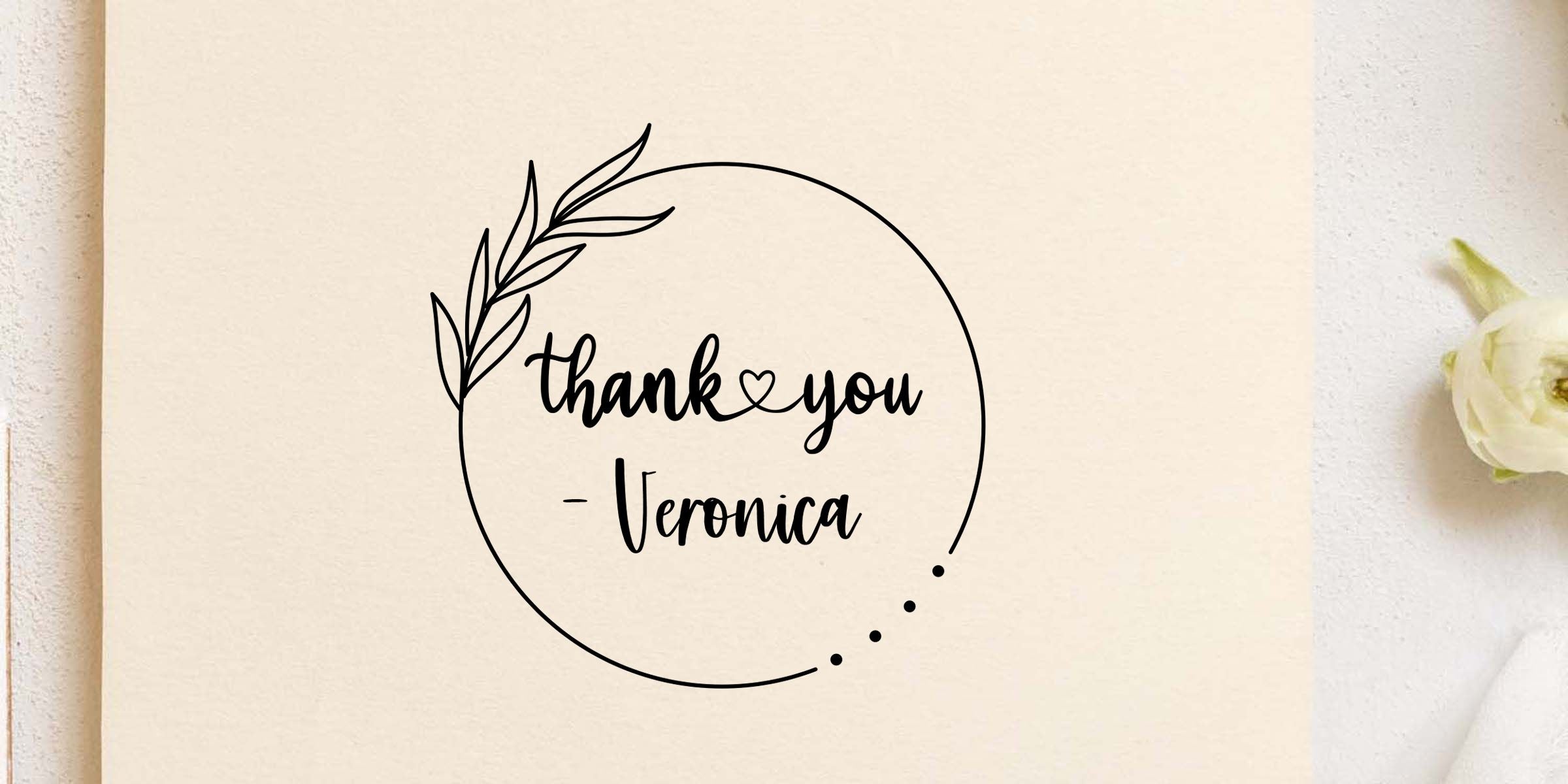 Elegant thank you Veronica calligraphy design with botanical leaf wreath on a cream background and a white flower accent