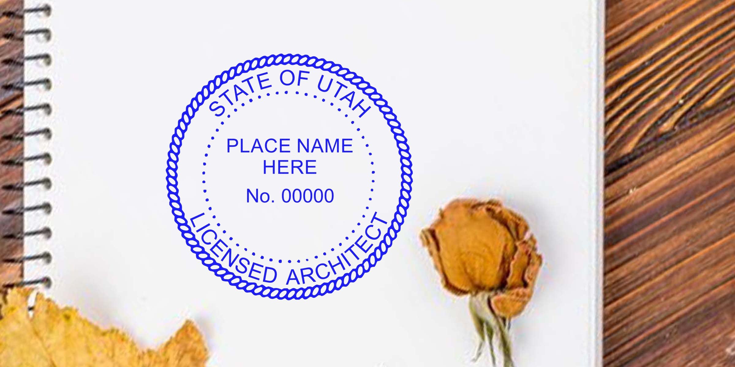 Utah Architect Stamp on notebook with dried flower, wooden table background, highlighting Architect Stamp Utah and Utah Architect Stamp Law.