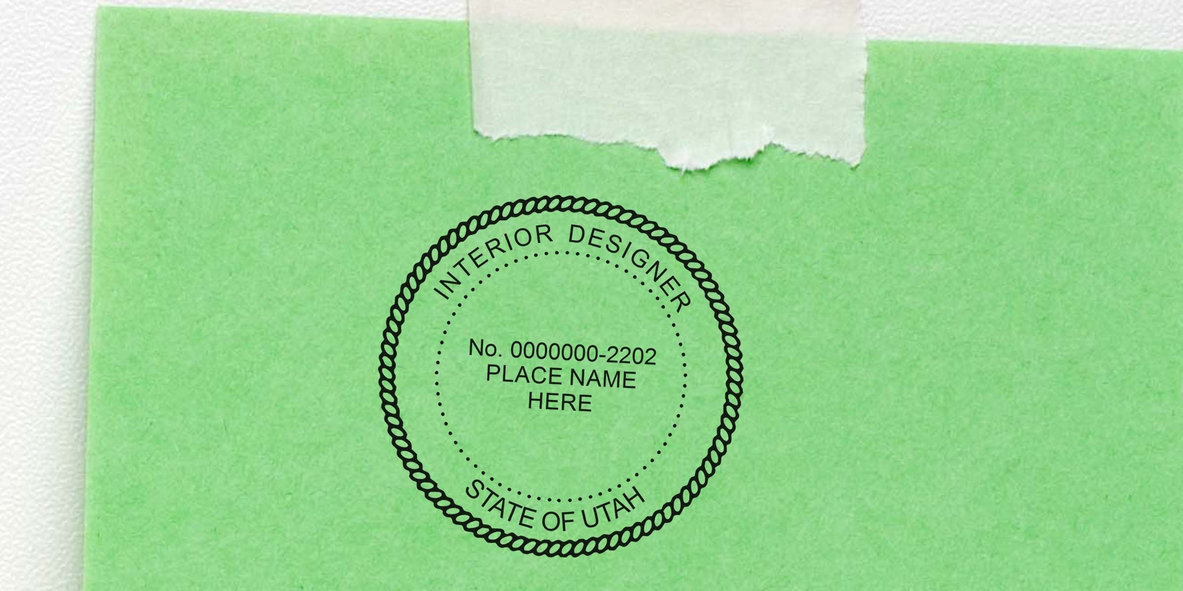 Utah interior designer certification stamp on green paper with torn tape, showing seal certification process.