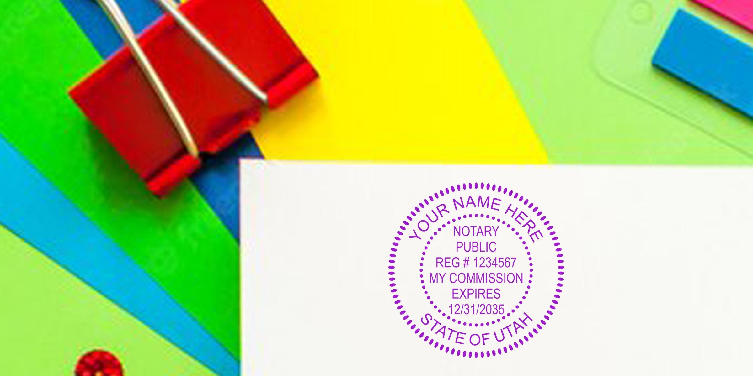UT Notary Seal on white paper with colorful office supplies background, Utah state notary commission seal, official stamp image representing Trusted Notary Services.