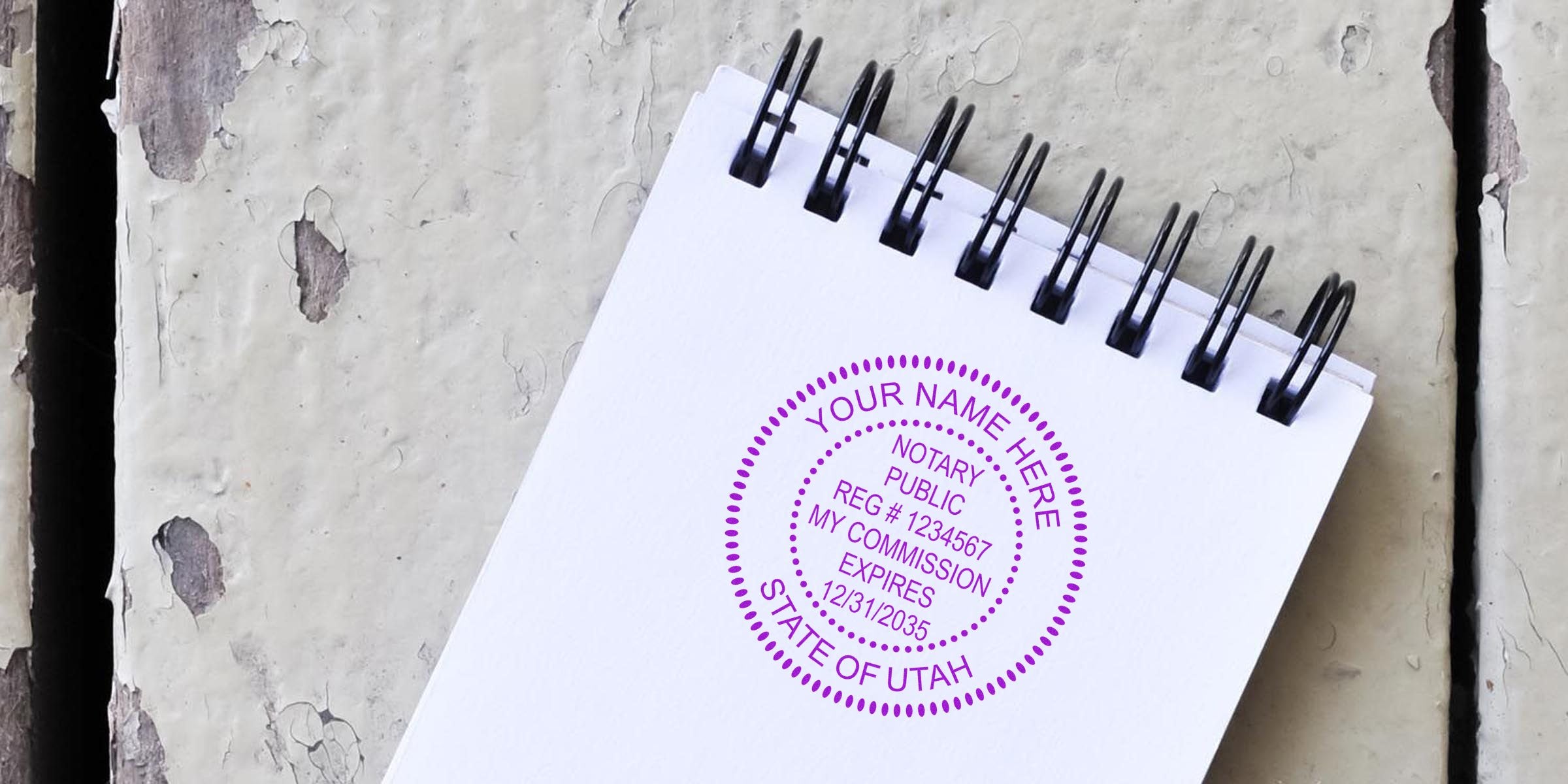 Utah notary stamp on white spiral notebook with state commission details, highlighting trusted notary supplies.
