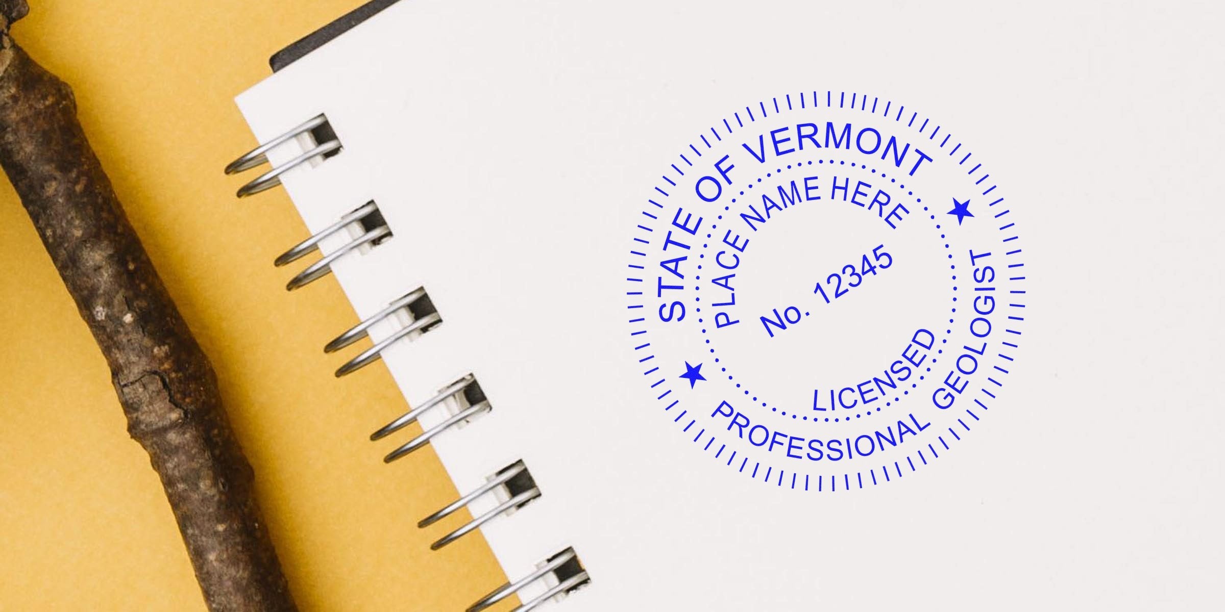 Vermont Professional Geologist Stamp on a white spiral notebook with a wooden stick, set against a yellow background, highlighting Geologist Stamp Requirements in Vermont.