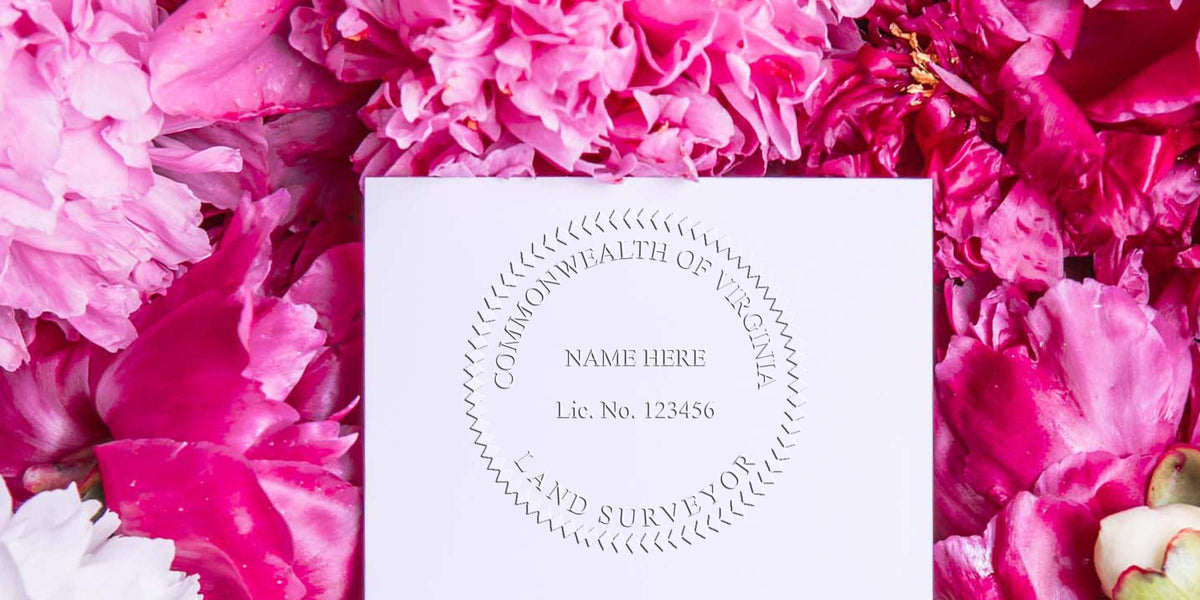Virginia land surveyor license seal embossed on white paper, encircled by pink flower petals, highlighting seal embosser tips.