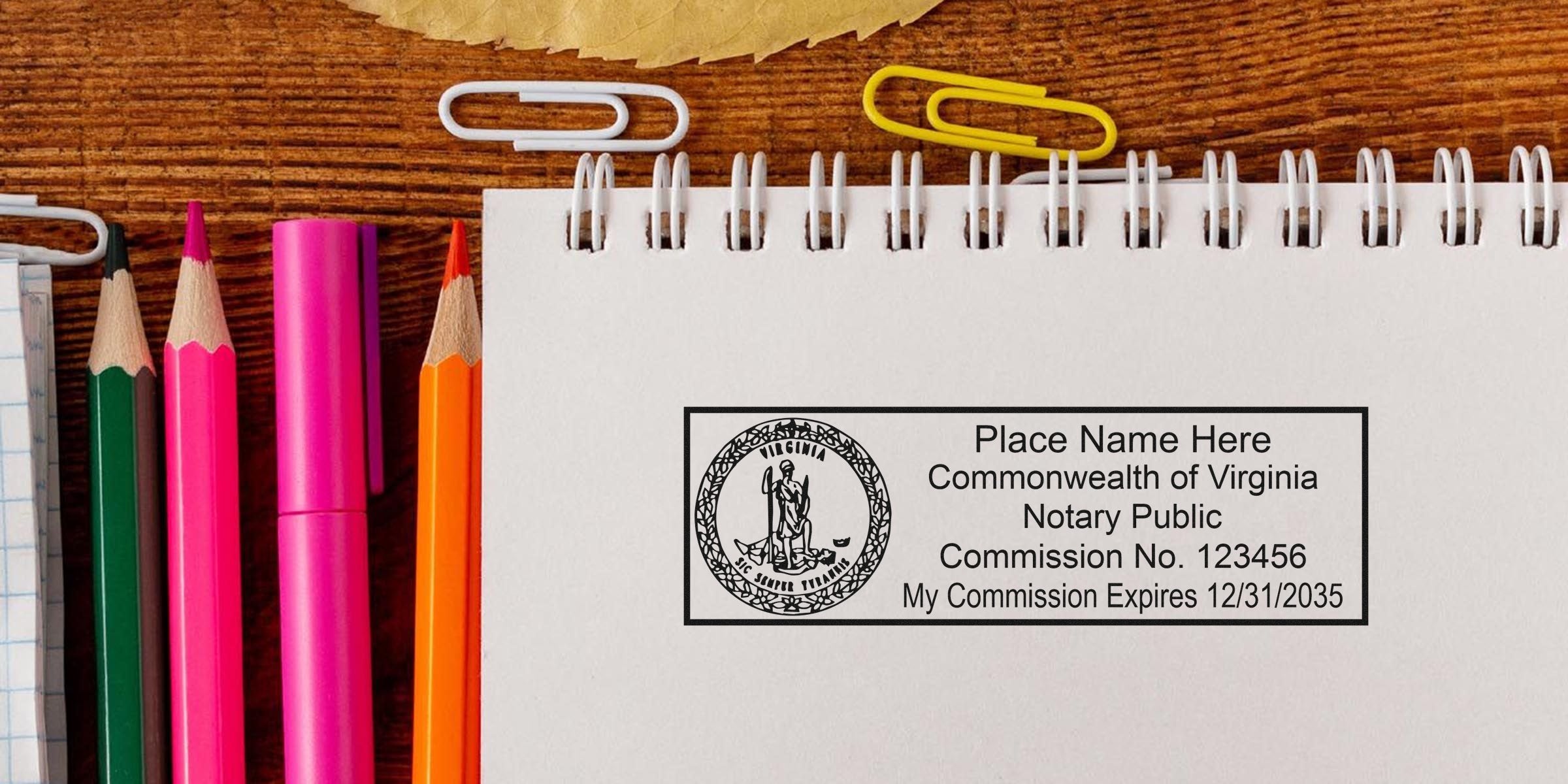 Virginia Notary Public stamp on a notebook with colored pencils and paper clips, demonstrating adherence to Notary Seal Guidelines.