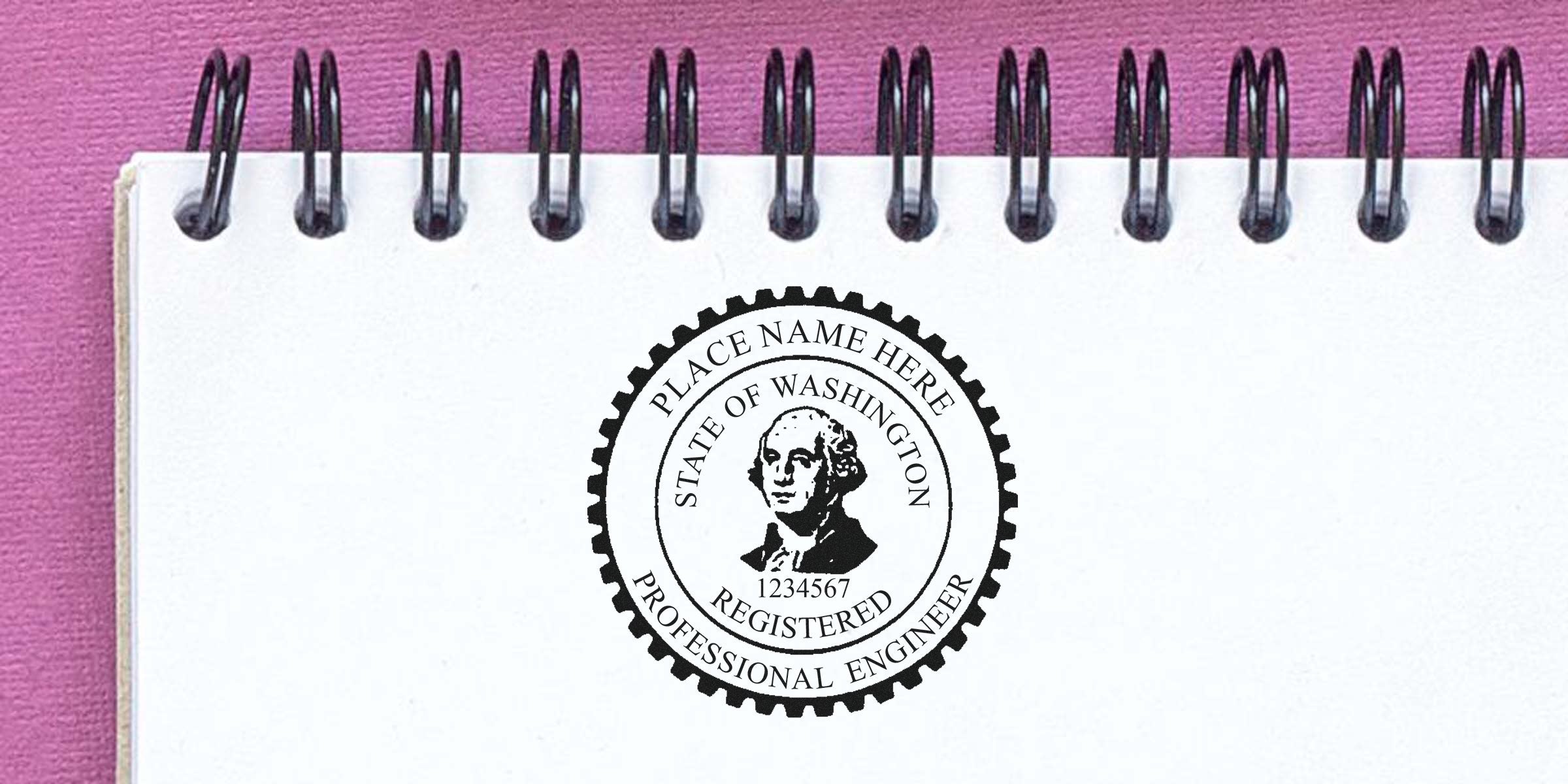 Washington engineer stamp on white spiral notebook with purple background, showing professional engineer seal and replacement stamp.