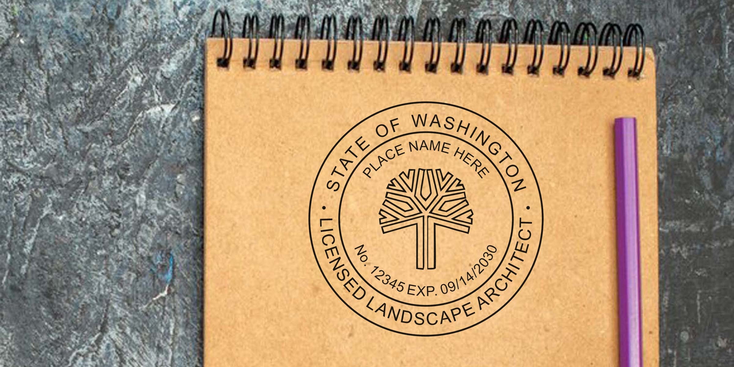 Washington State Landscape Architect Stamp on notebook with purple pen, showing the Washington State Landscape Certification seal on a textured surface.
