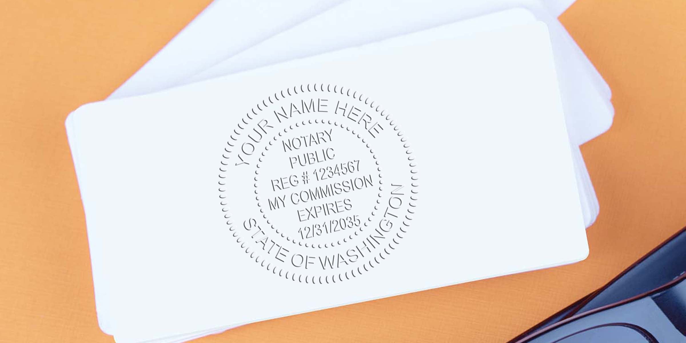 Washington notary embossing seal on white card showing registration and commission expiration details, WA notary stamp.