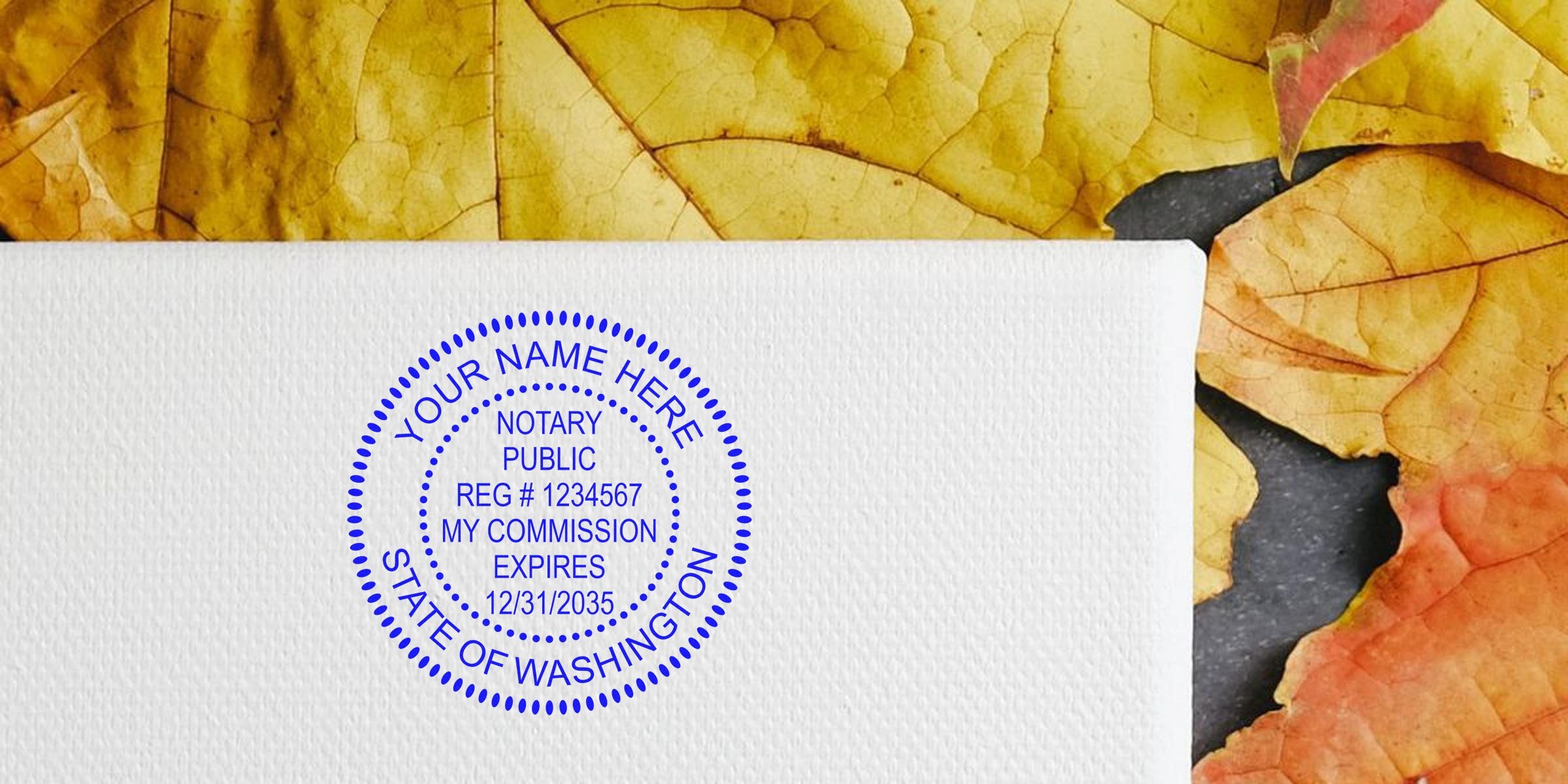 Washington notary public stamp on white paper with autumn leaves, symbolizing notary stamp renewal and renewal requirements.