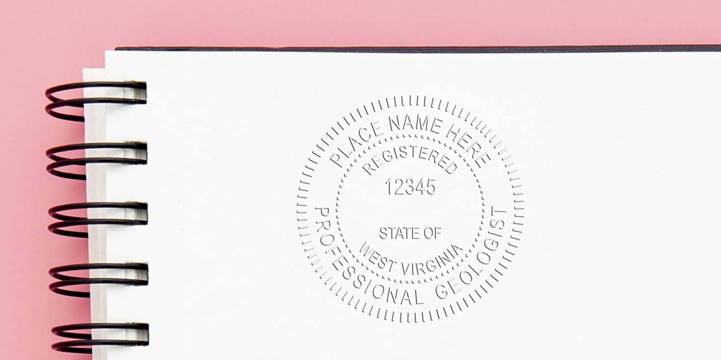 West Virginia geologist stamp embossed on white spiral notebook with pink background, showcasing a professional geologist stamp design.
