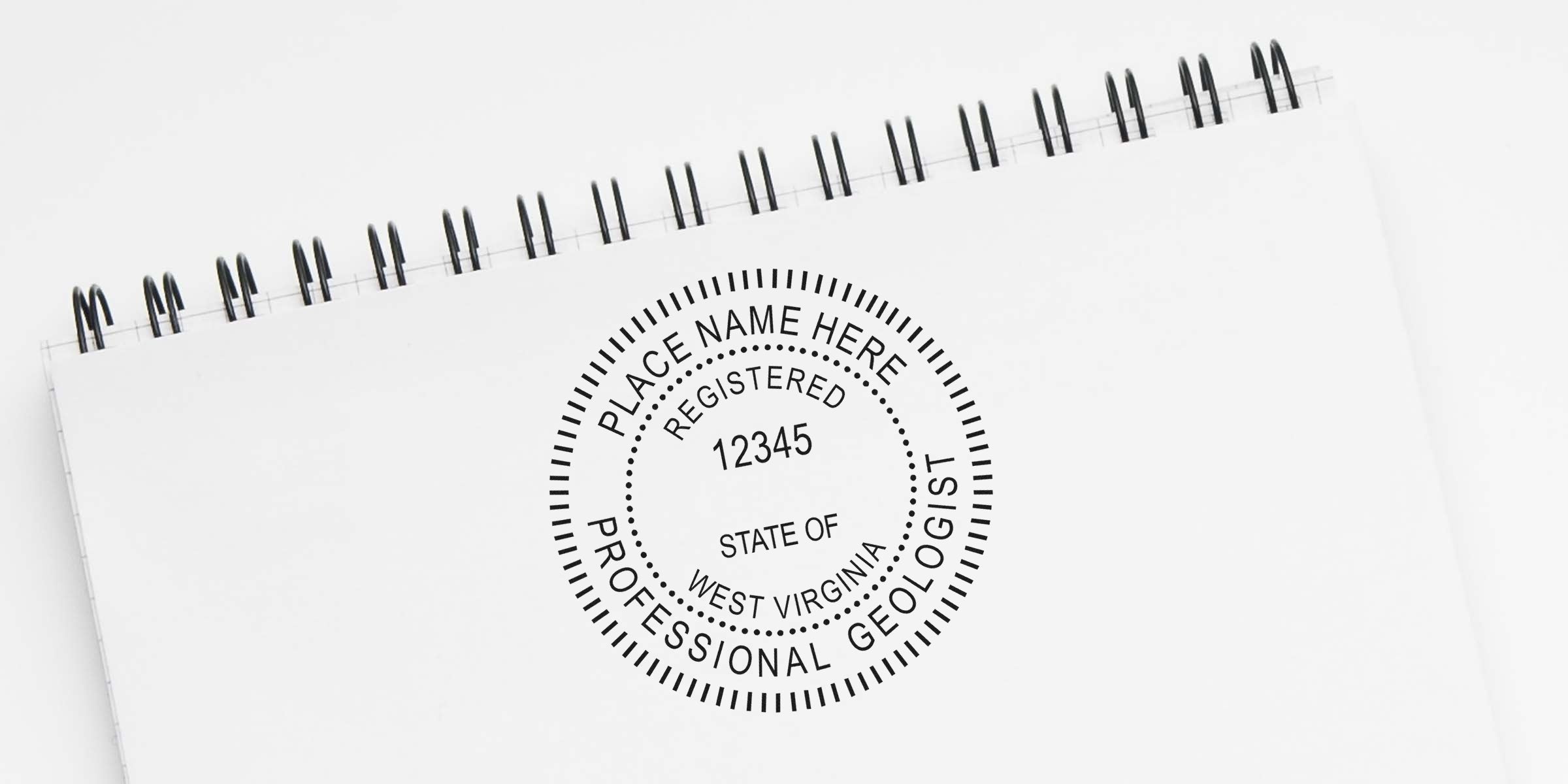 West Virginia geologist seal embossed on a white spiral notebook with embosser tips visible.