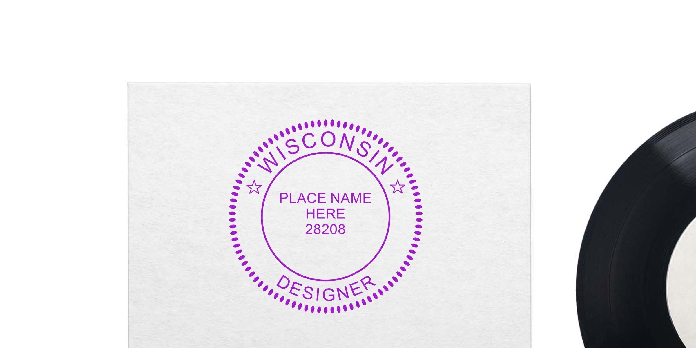 Custom interior designer stamp for Wisconsin branding on white paper, purple ink, vinyl record edge visible.