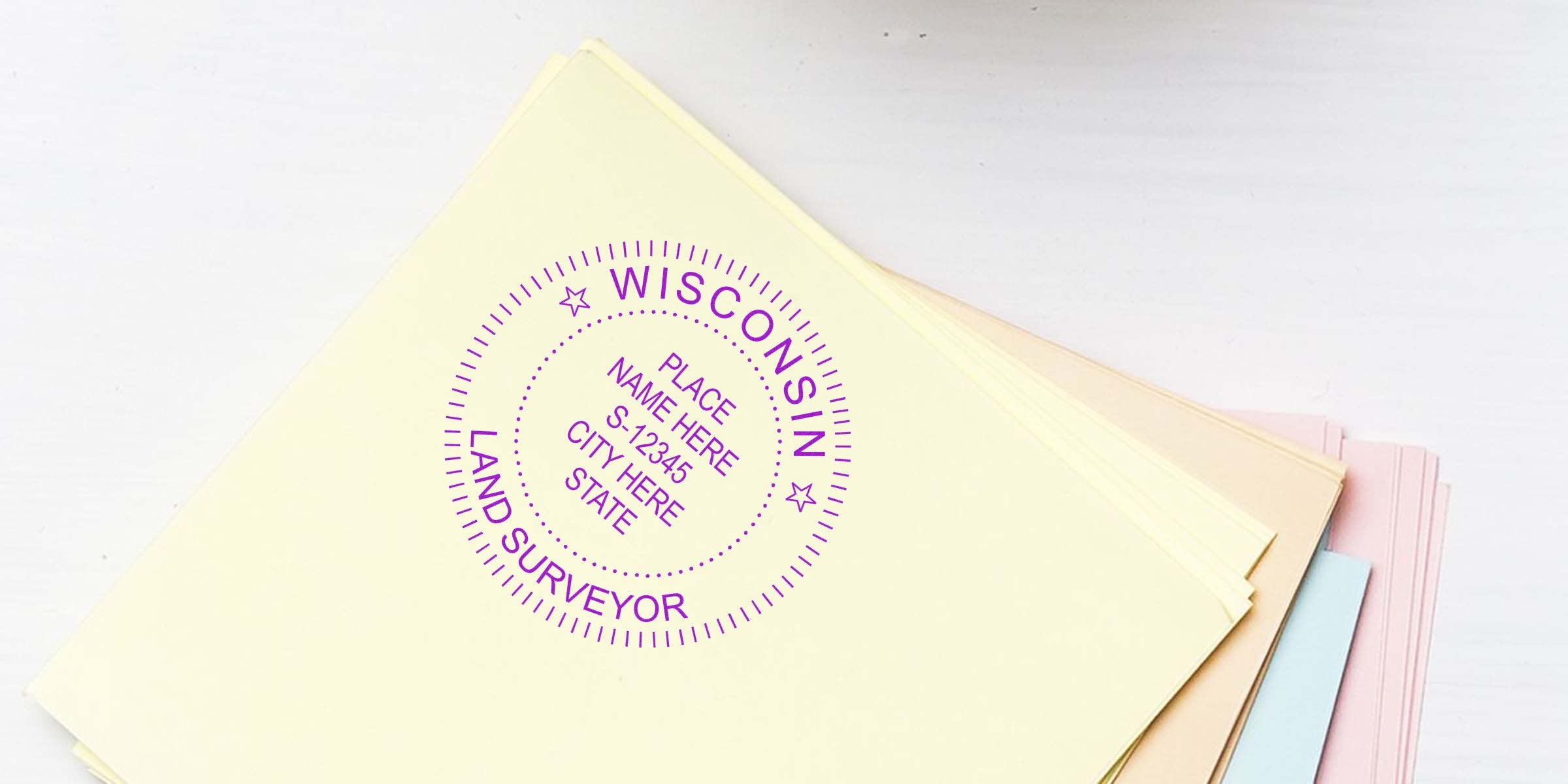 Custom Wisconsin land surveyor seal embossed on pastel paper stack, meeting all embosser compliance standards.