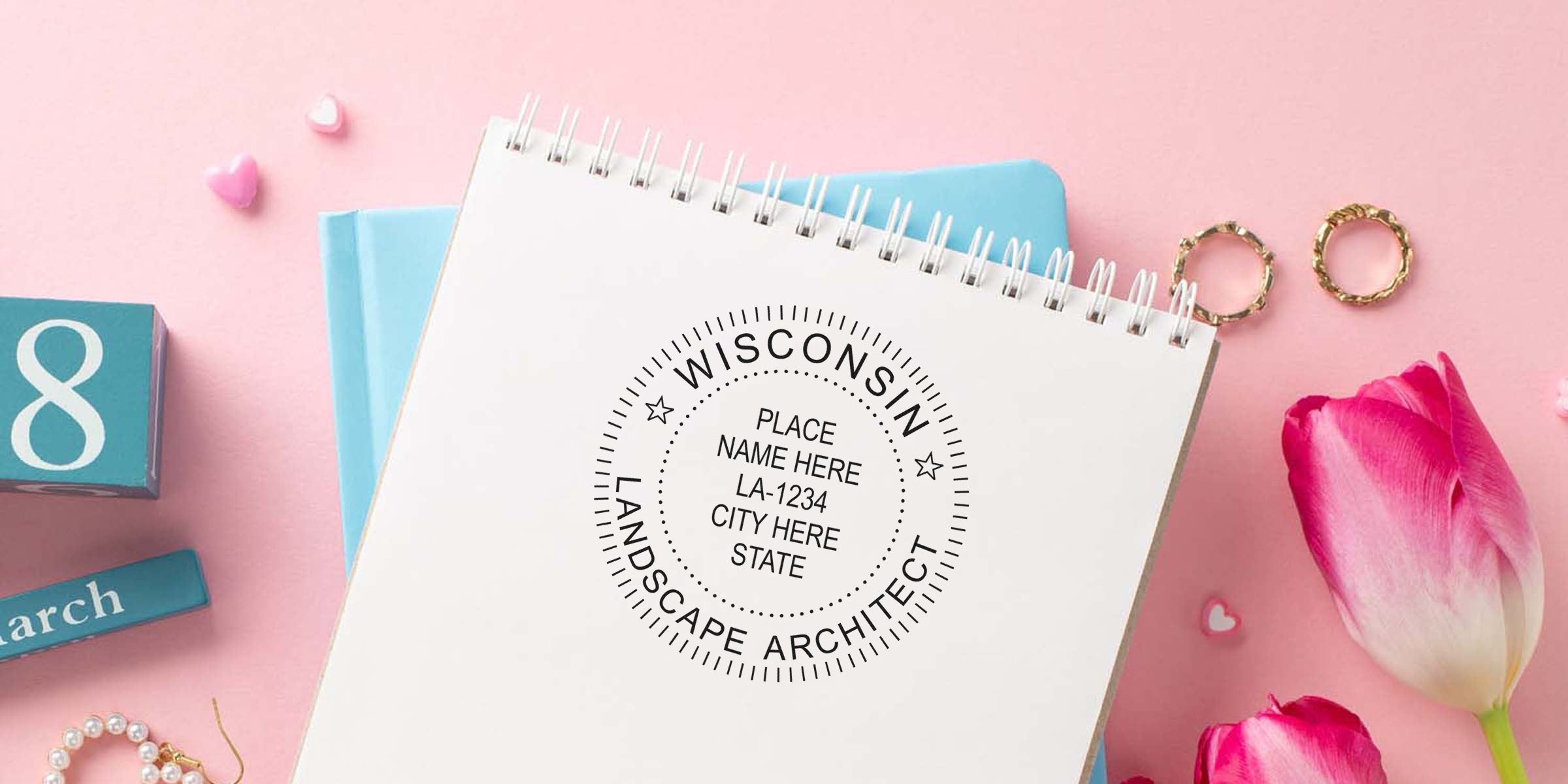 Wisconsin landscape architect license stamp on spiral notebook with pink tulips and gold rings on pastel pink background, showing landscape architect stamp rules.