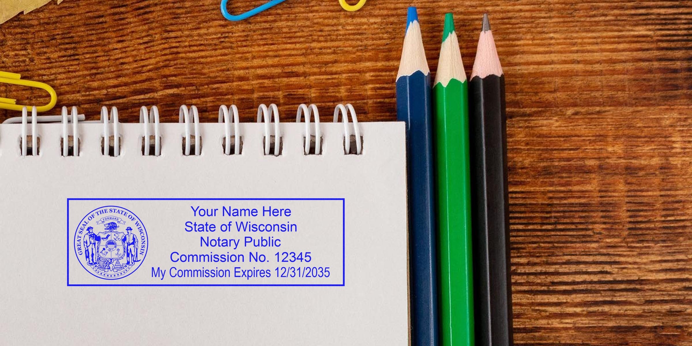 Wisconsin notary stamp on notebook with colored pencils and paper clips on wooden desk, displaying notary seal details.