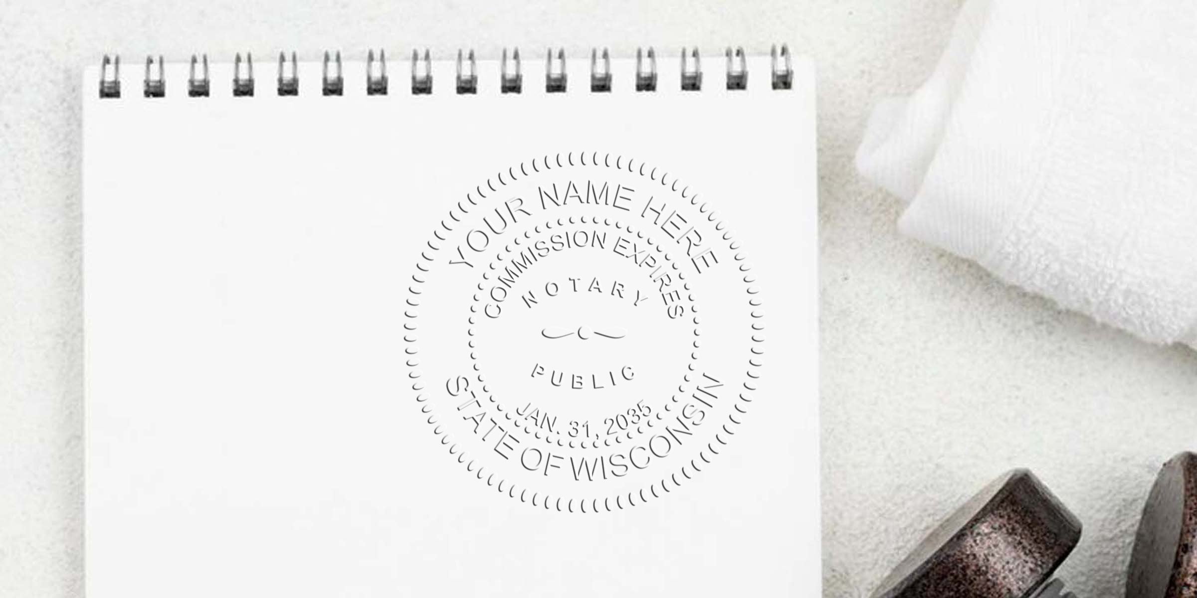 Wisconsin Notary Seal on white notebook showing commission expiration date, featured in the Best Notary Seal Guide.