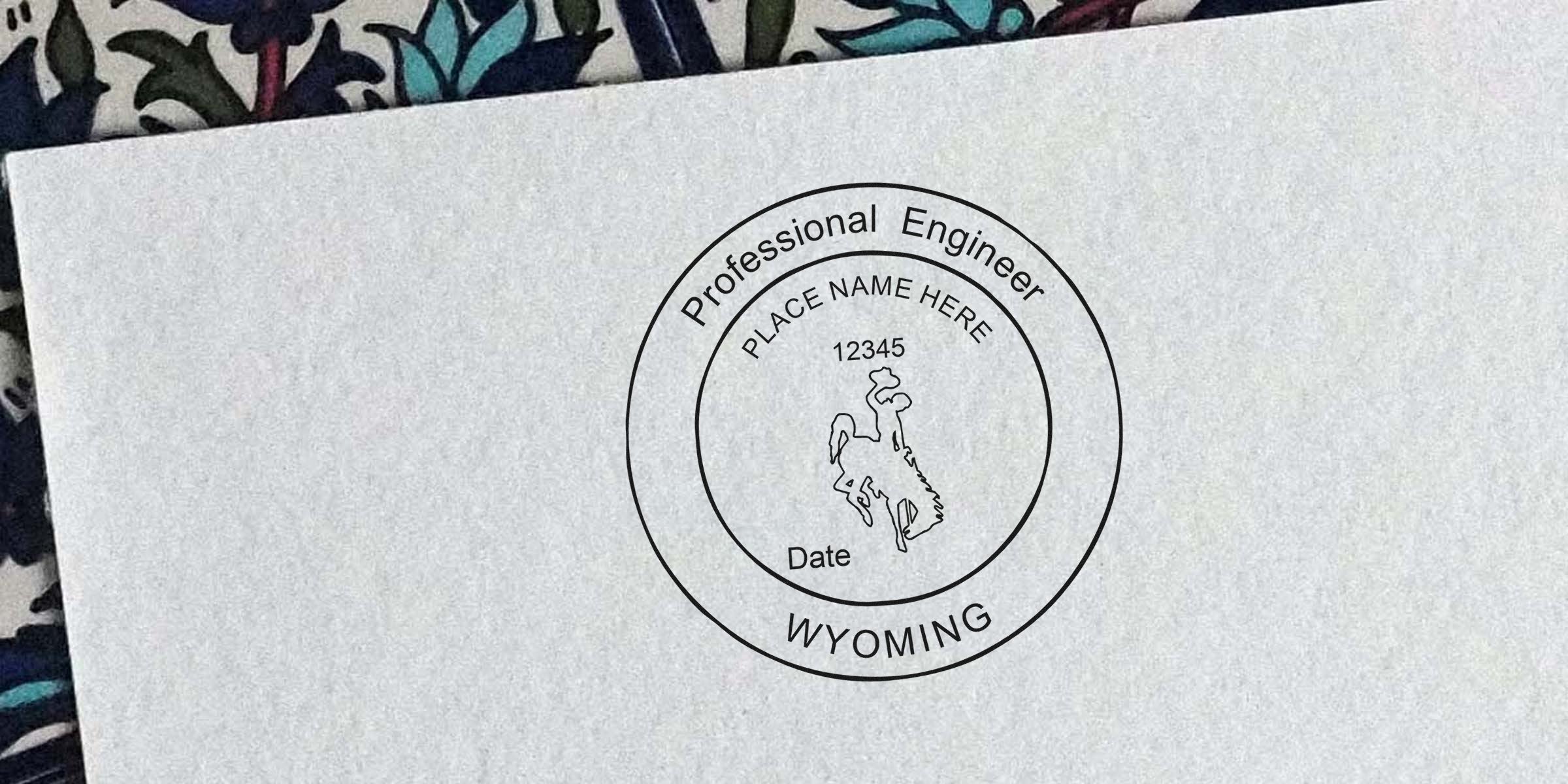 Wyoming engineer stamp with Professional Engineer seal and bucking horse logo on paper, showing the engineer stamp ordering process.