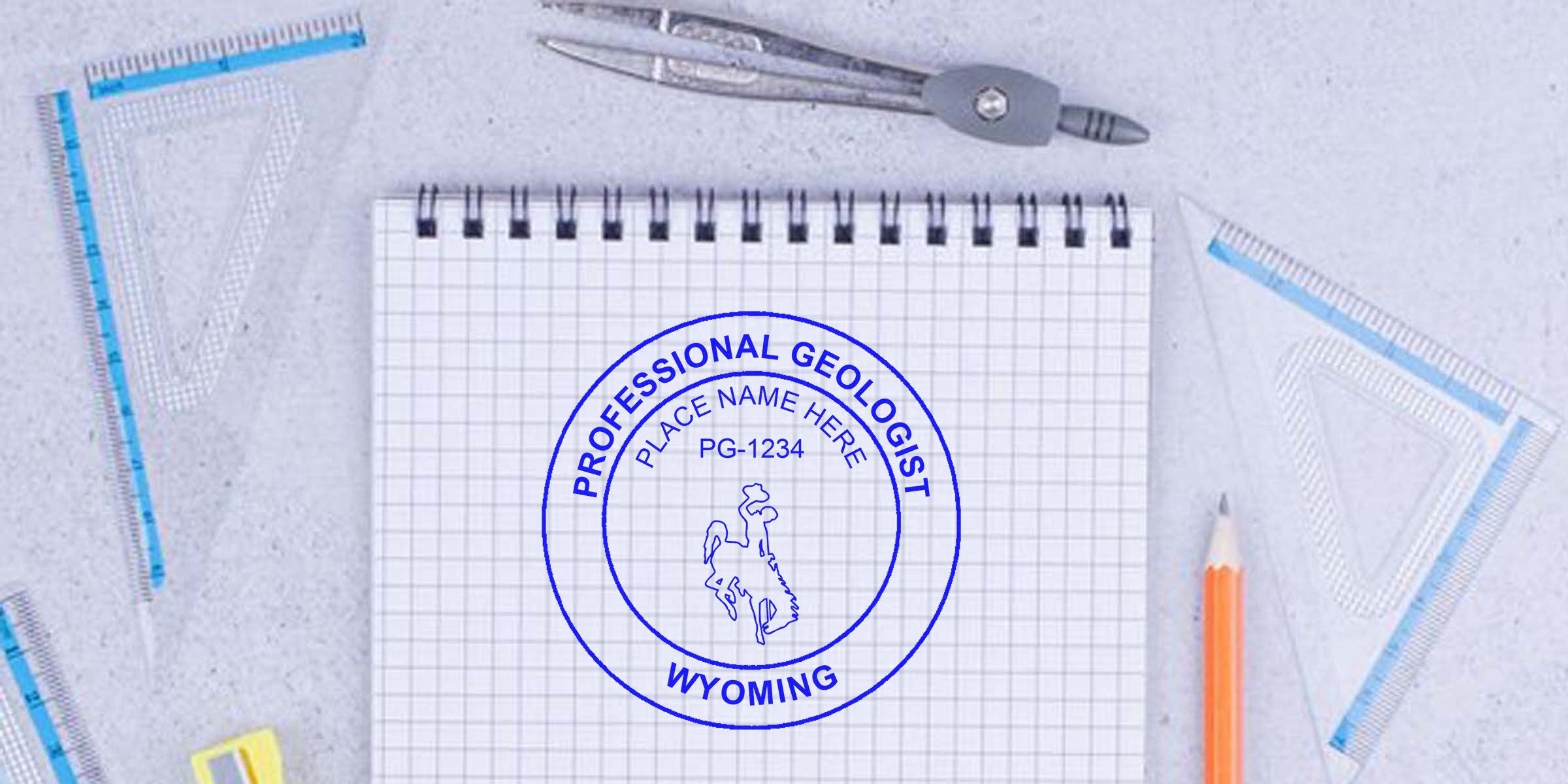 Wyoming Professional Geologist Seal on graph paper with drawing tools and pencil, showing how to get a Geologist Seal in Wyoming.